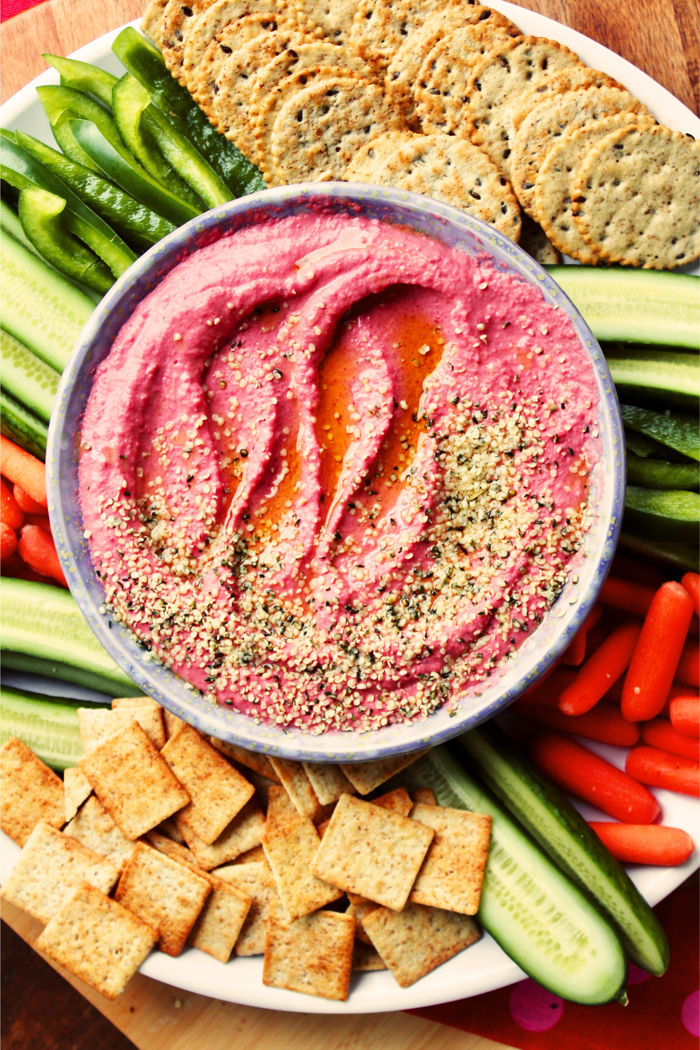 A tray of hummus, veggies and crackers