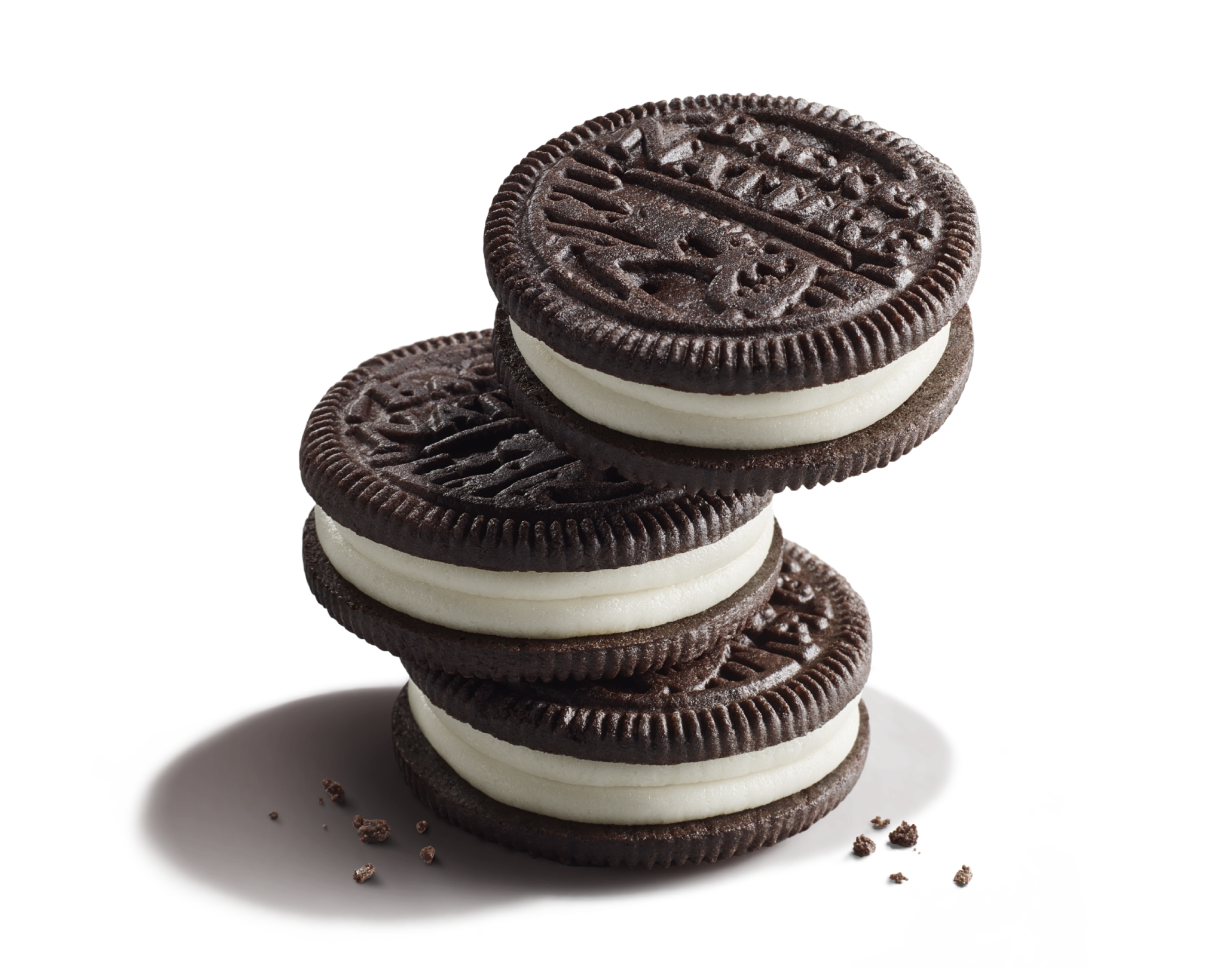 Three stacked Double Classic Creme Sandwich Cookies with chocolate cookie crumbs