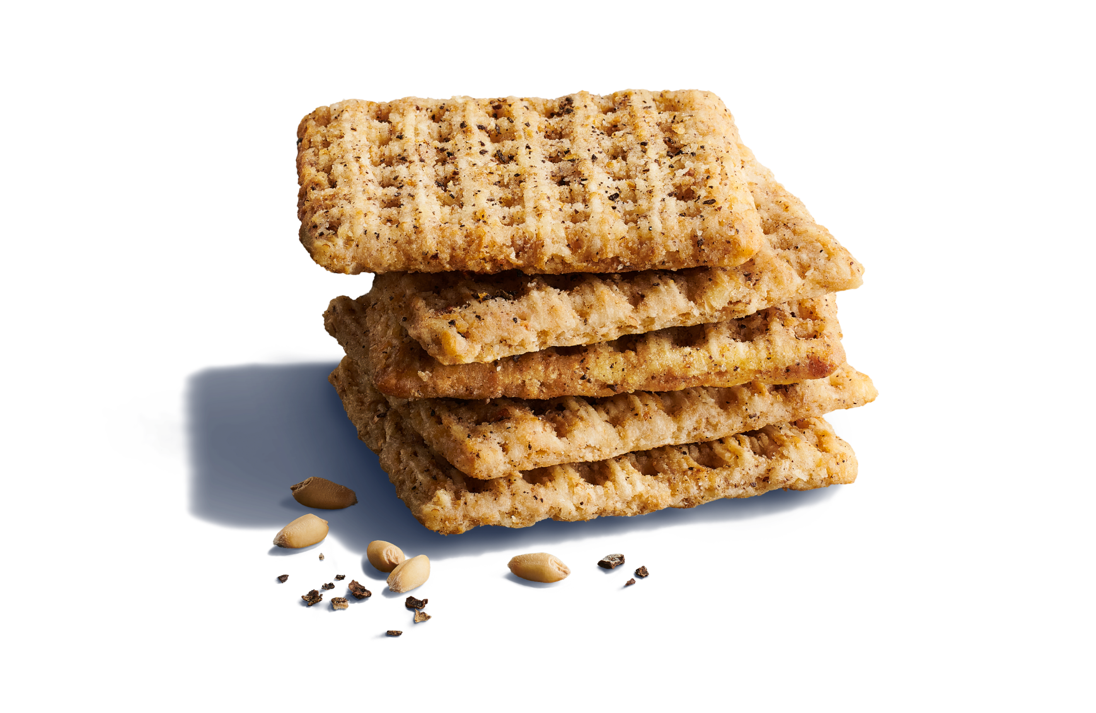 Close-up of five whole-grain woven wheat crackers with whole grains and black pepper granules on a vibrant blue background.