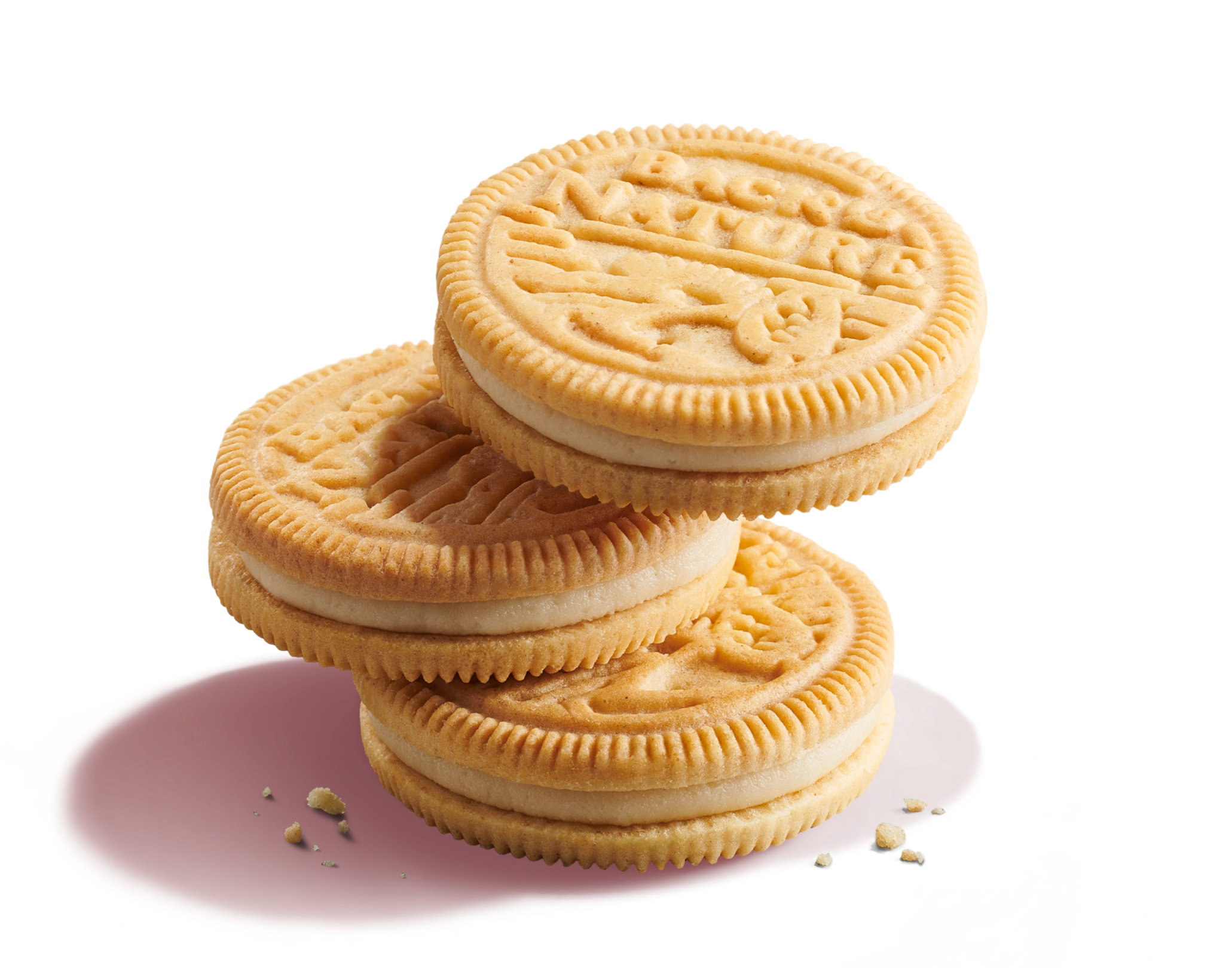 Three stacked Golden Creme Sandwich Cookies with vanilla cookie crumbs, one cookie is bitten