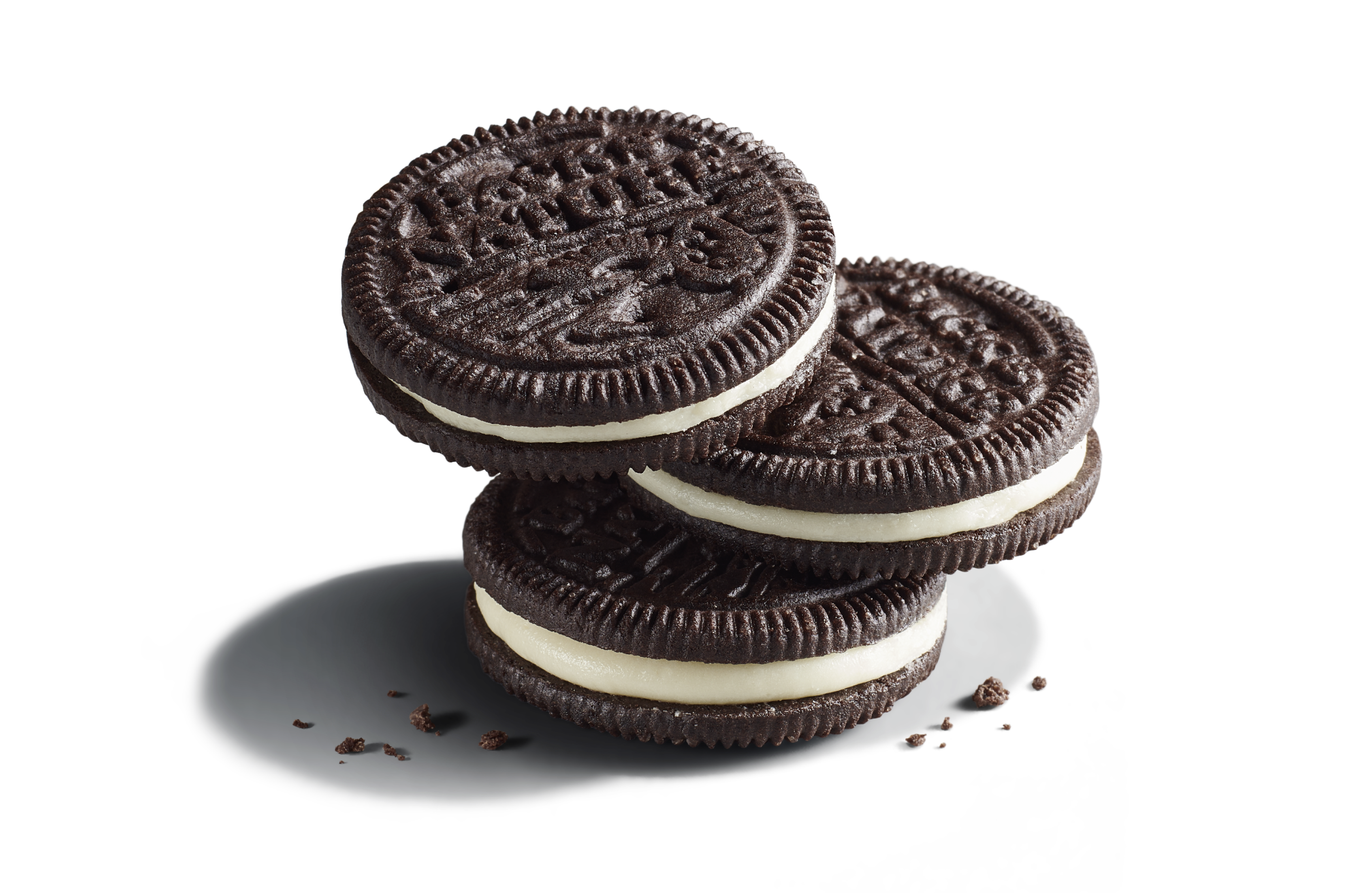 Three stacked Classic Creme Sandwich Cookies with chocolate cookie crumbs