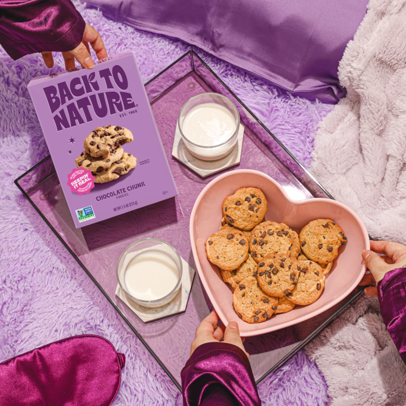 Back to Nature chocolate chunk cookies being served with milk in a purple slumber party themed setting