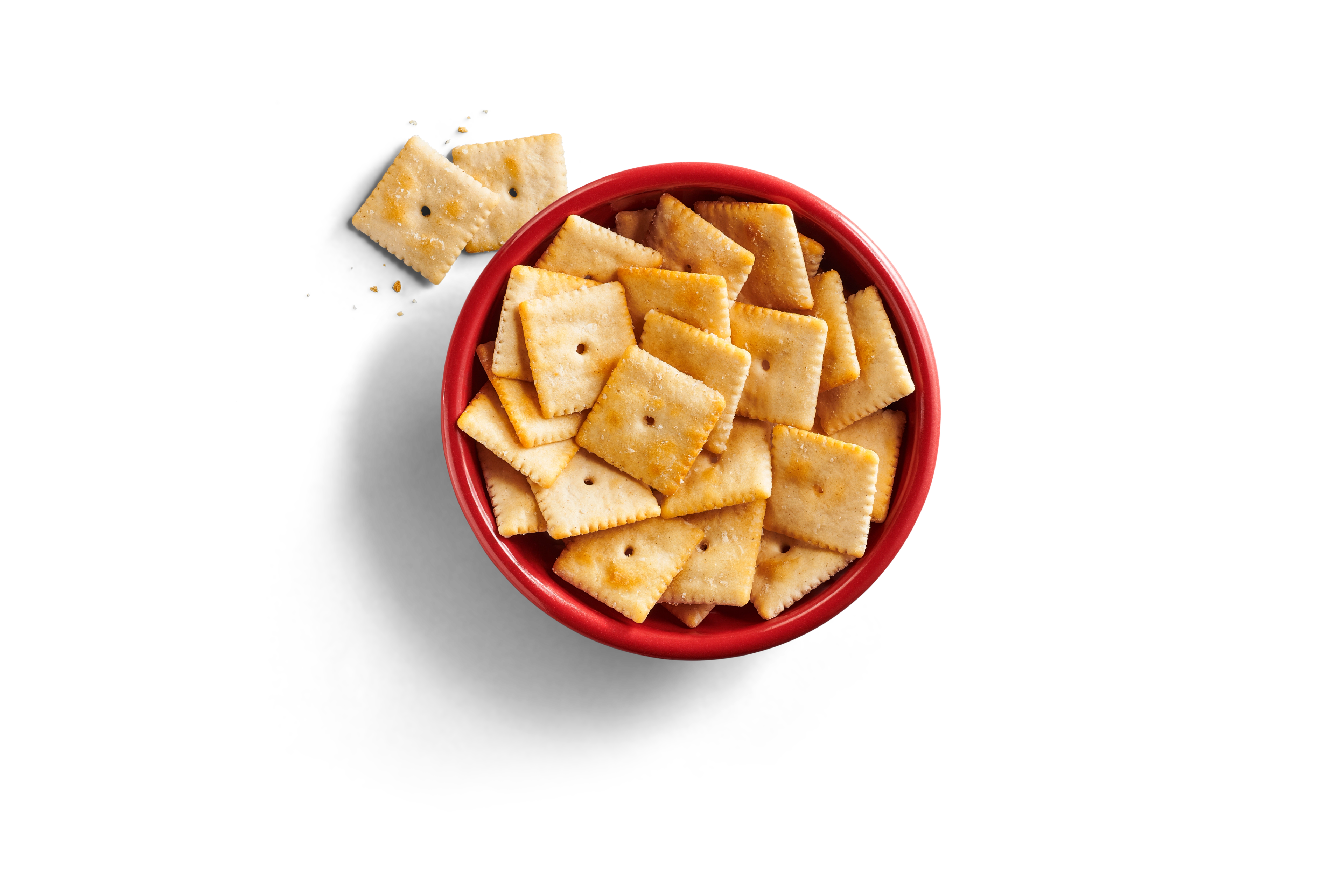 Close-up of a bowl of white chedda cheezy crackers with visible white chedda seasoning.