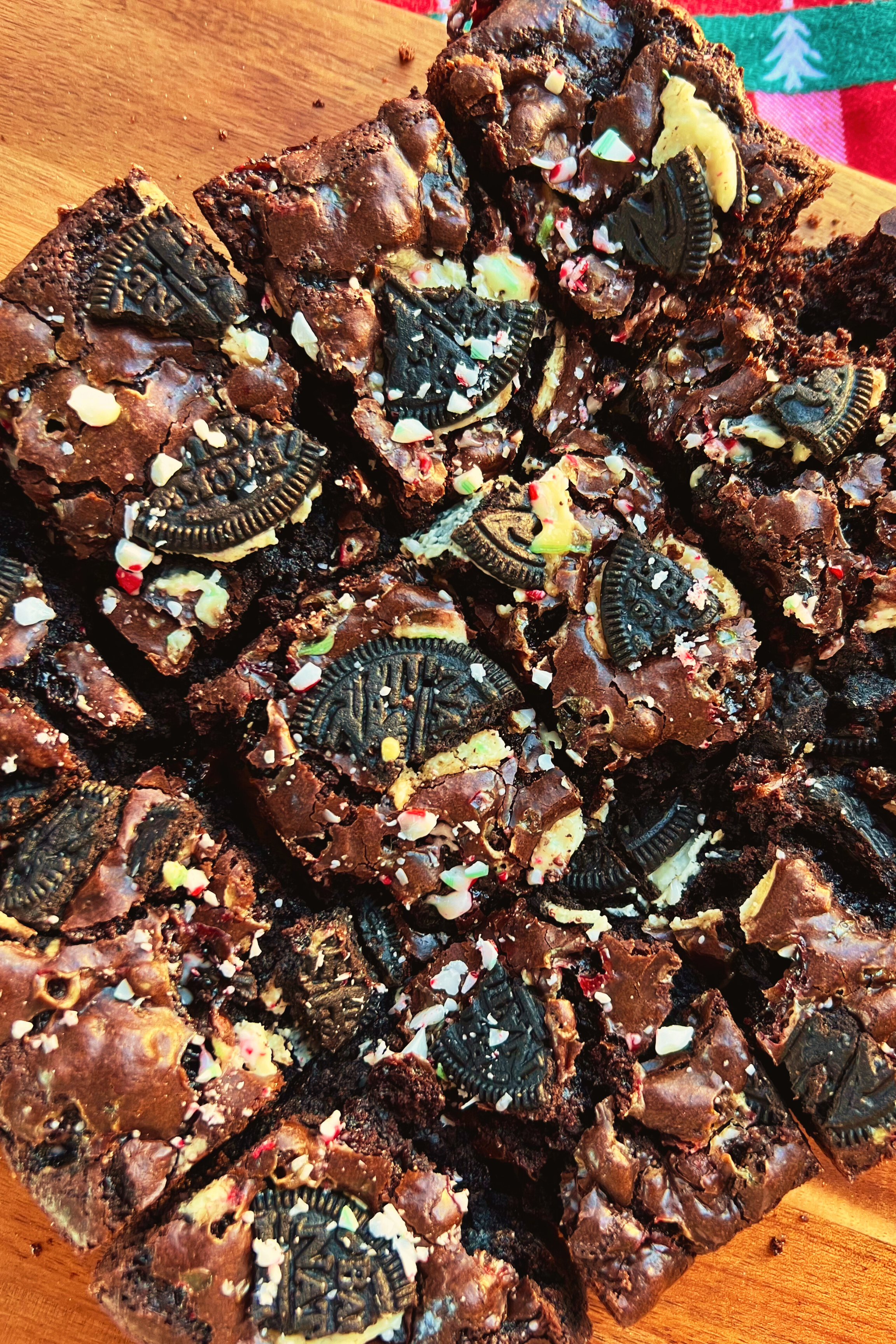 A close-up shot of brownies with cookies and peppermint embedded in the top