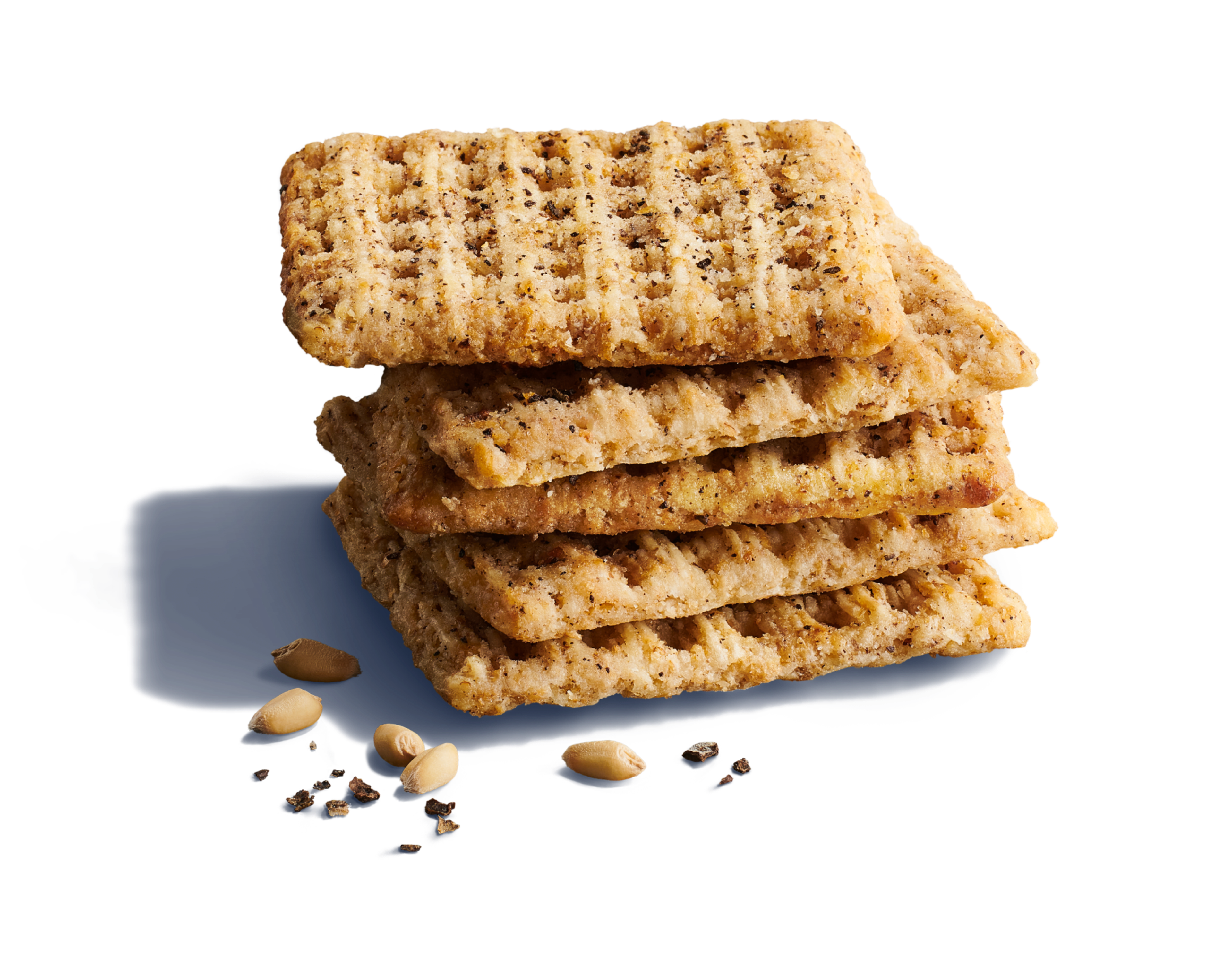 Close-up of five whole-grain woven wheat crackers with whole grains and black pepper granules on a vibrant blue background.