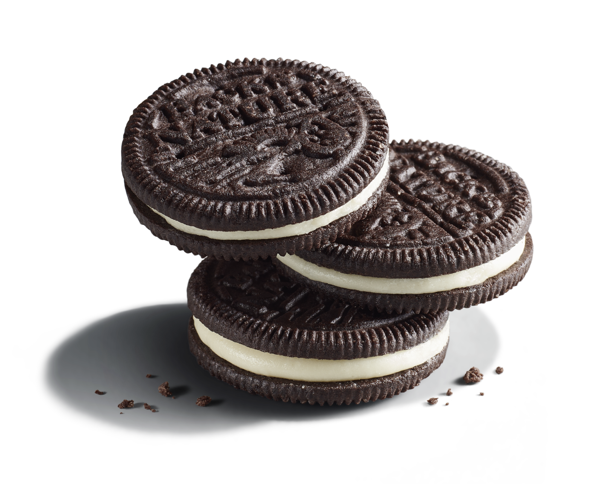Three stacked Classic Creme Sandwich Cookies with chocolate cookie crumbs