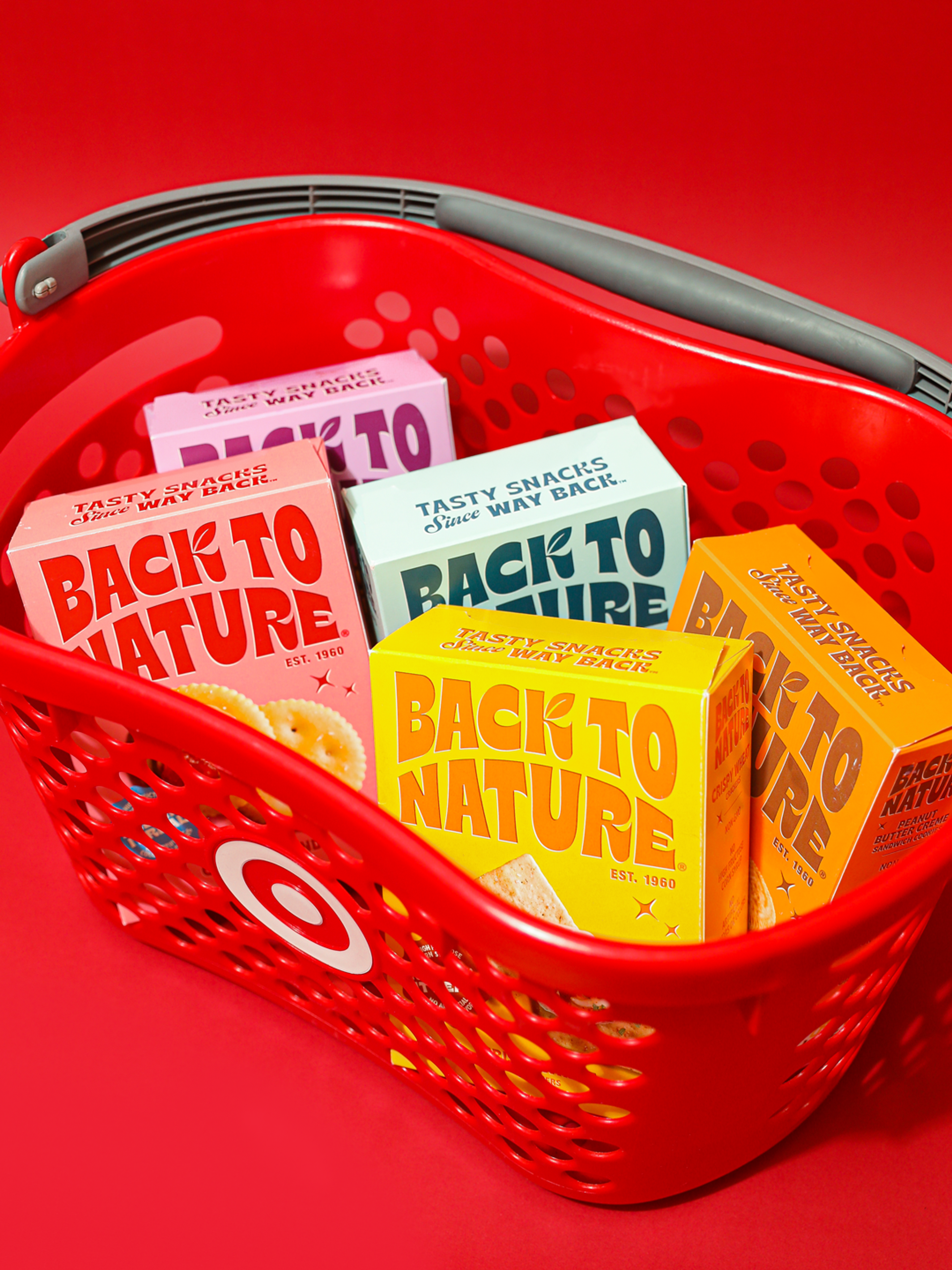 A red Target shopping basket full of Back to Nature cookies and crackers on a red background