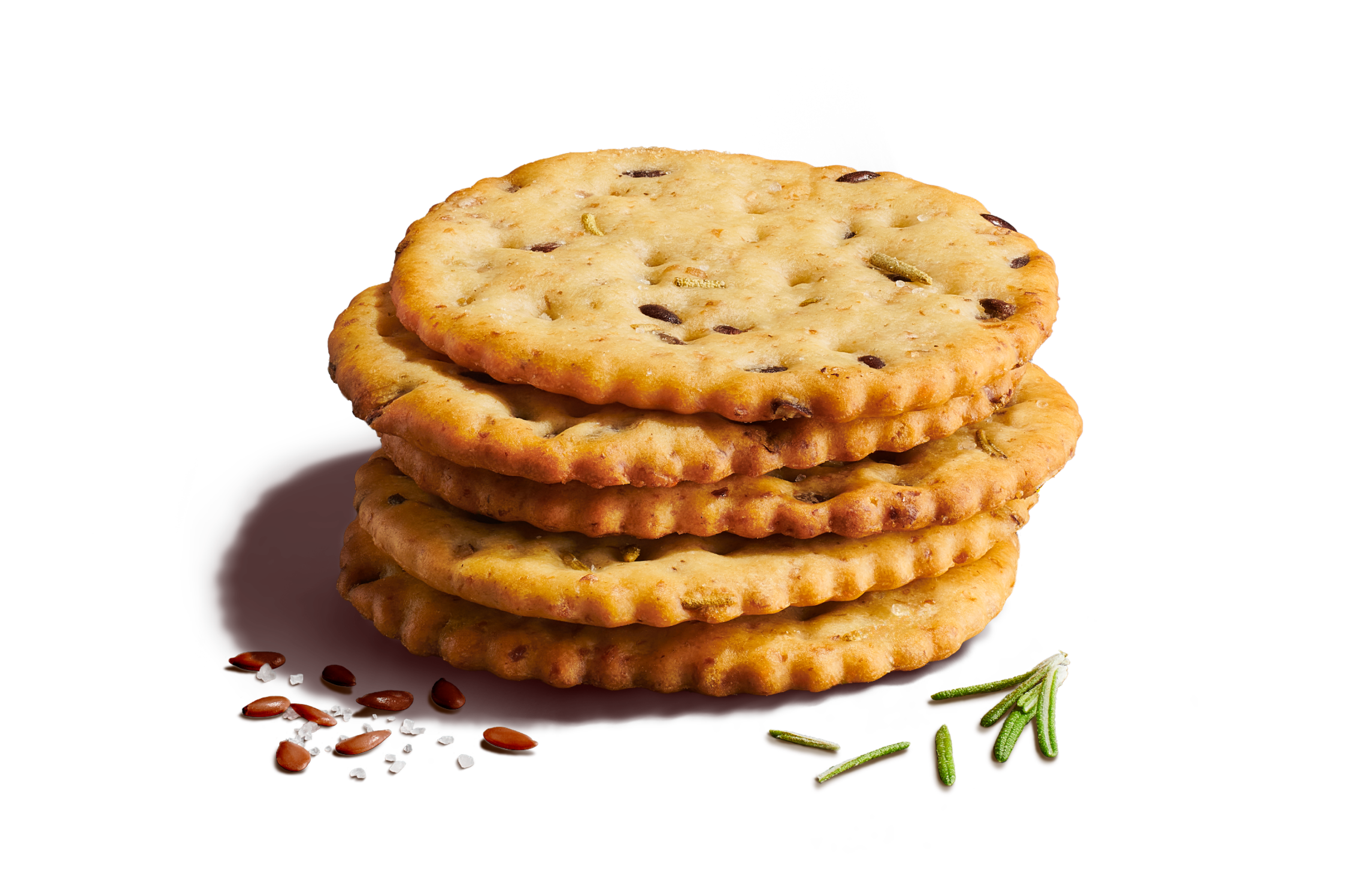 Close-up of five stacked crackers on a light yellow background with seeds, rosemary, and sea salt flakes.