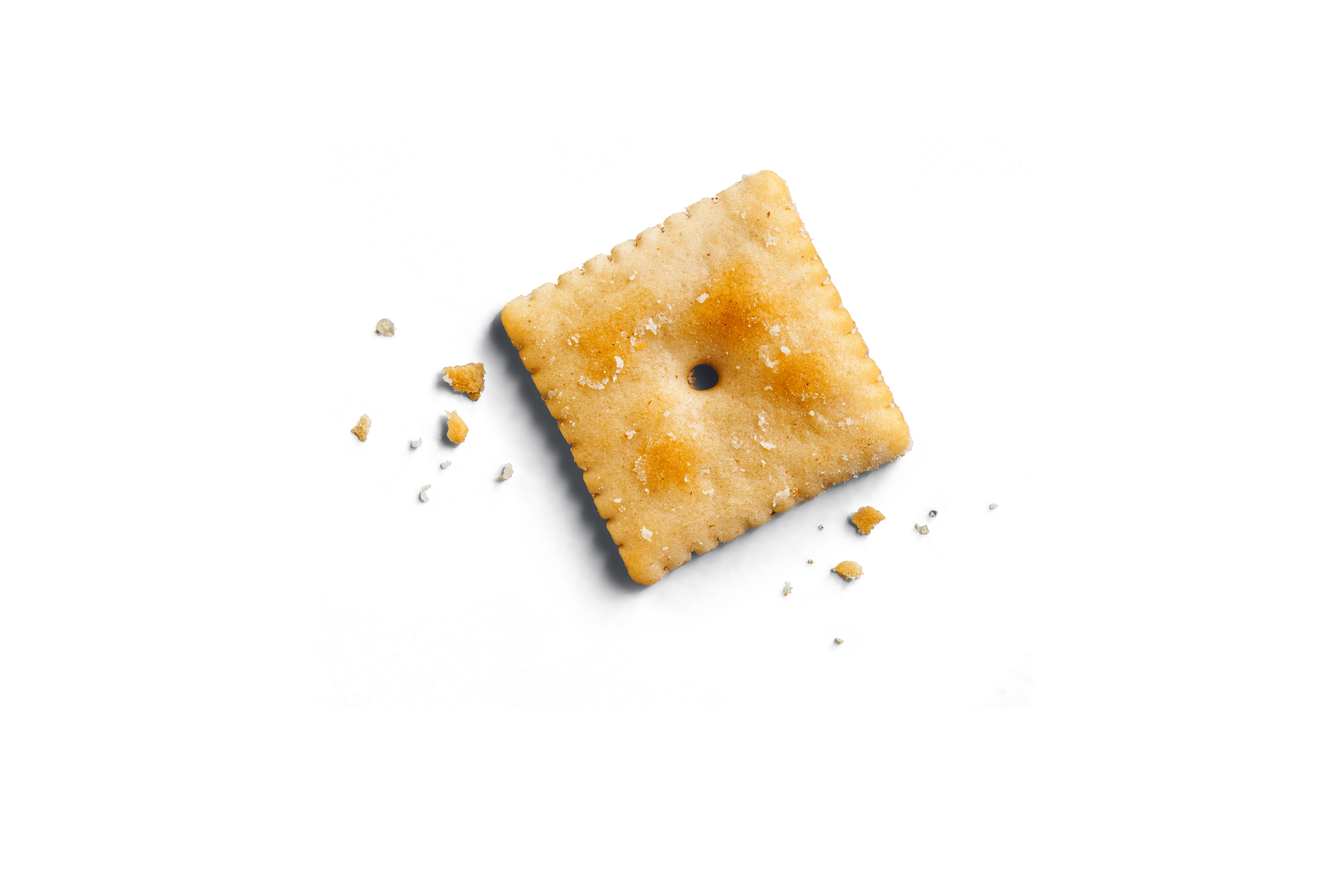 Close-up of a white chedda cheezy cracker, with white chedda seasoning visible.