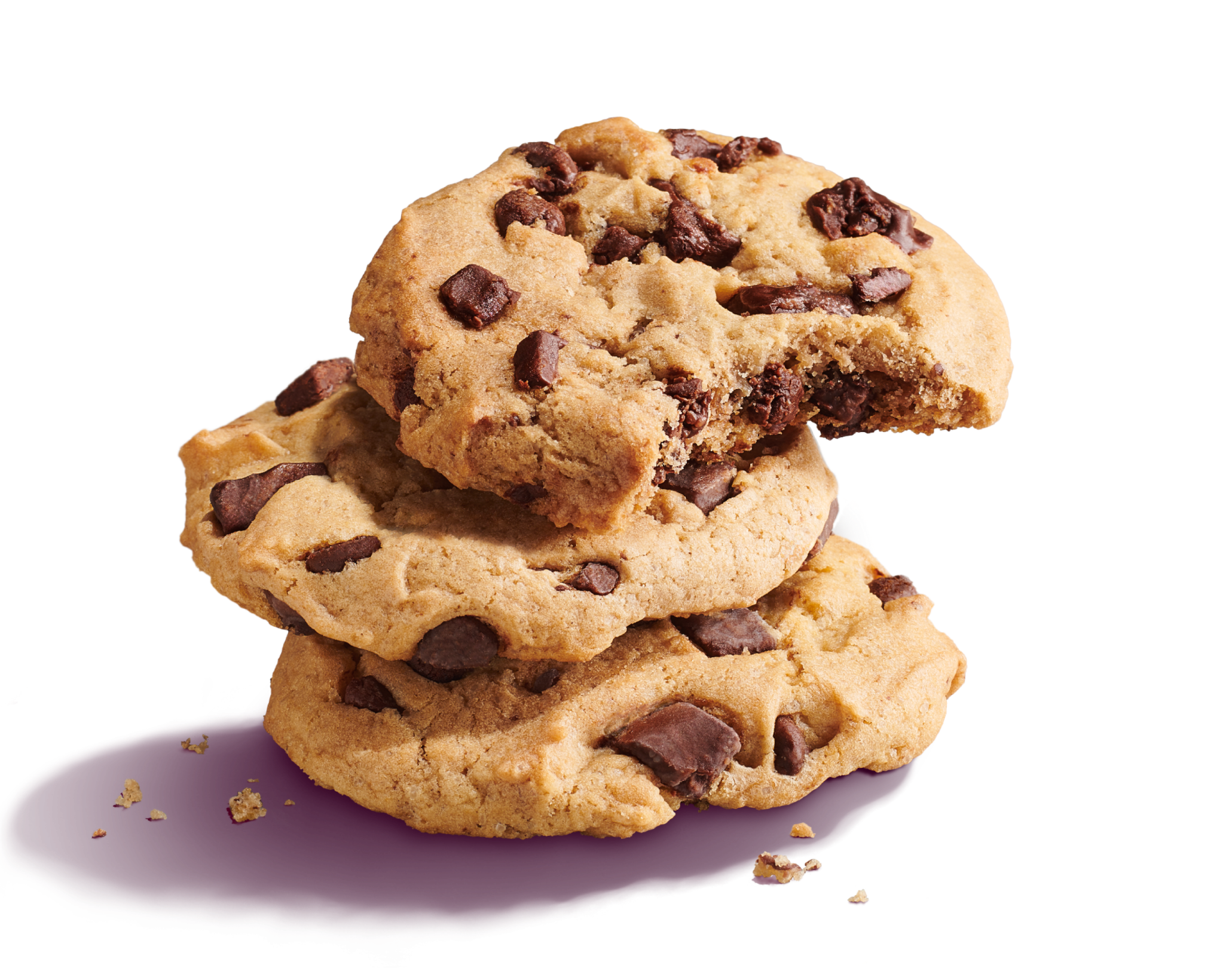 Three stacked Chocolate Chunk Cookies with cookie crumbs, one cookie is bitten