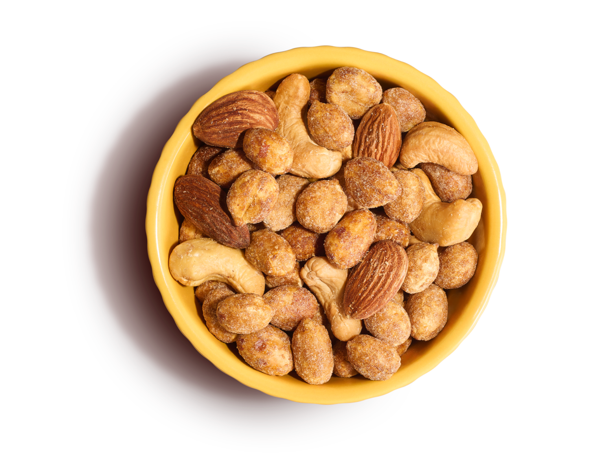 Light yellow bowl of honey roasted peanuts, salted cashews, and almonds on an yellow background.