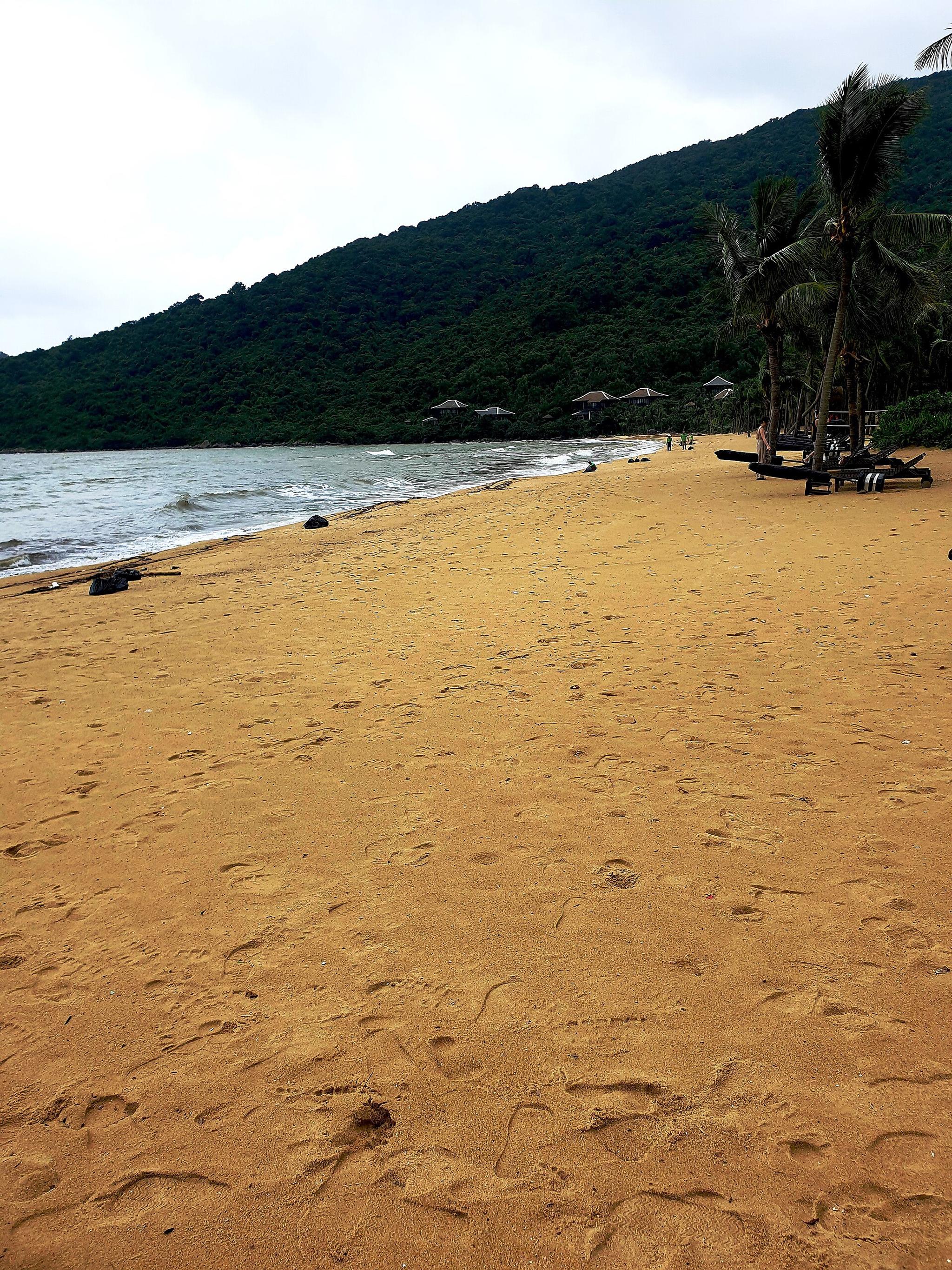 A quiet beach under the forested slopes of the Son Tra Peninsula.