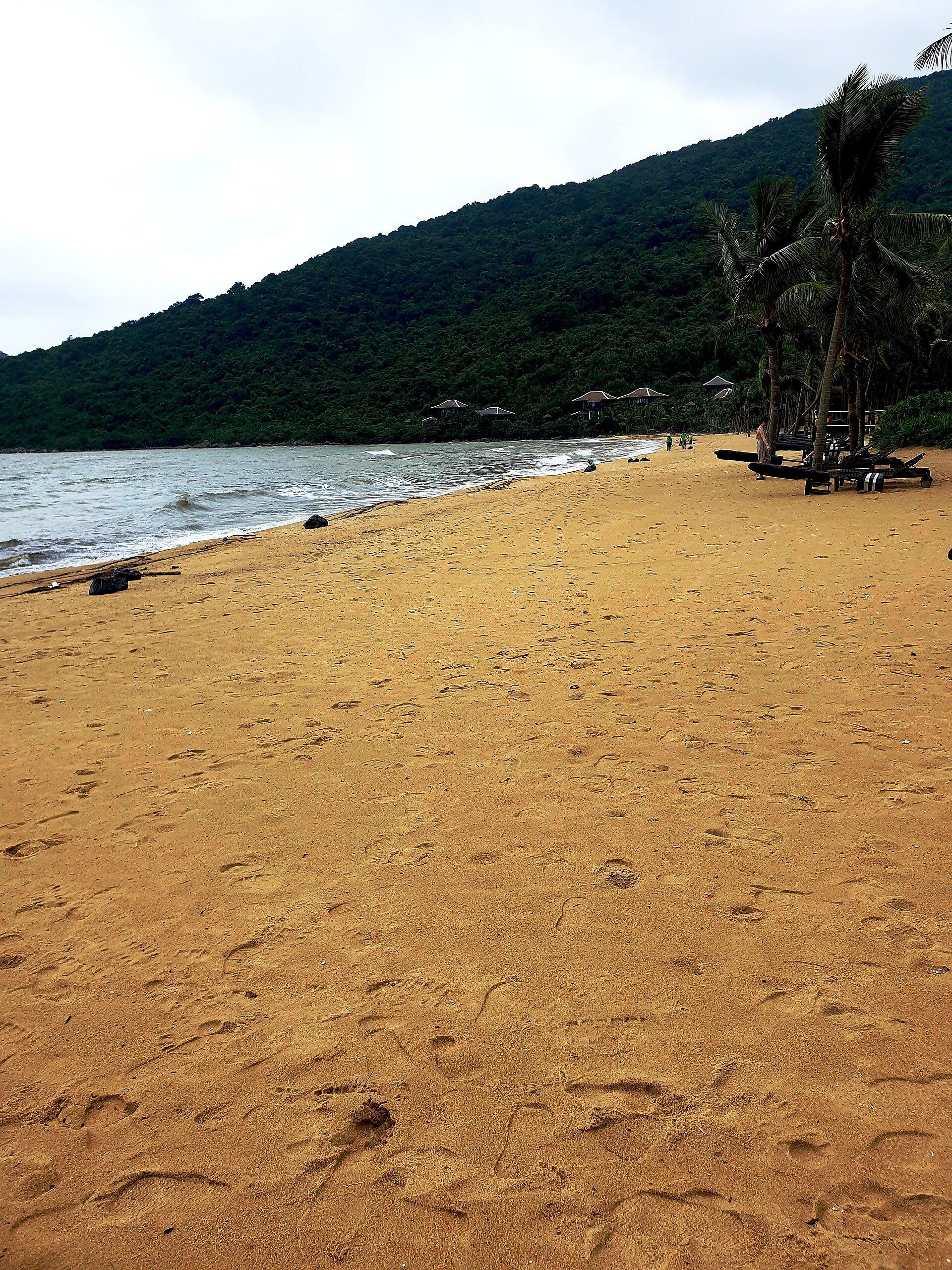 A quiet beach under the forested slopes of the Son Tra Peninsula.