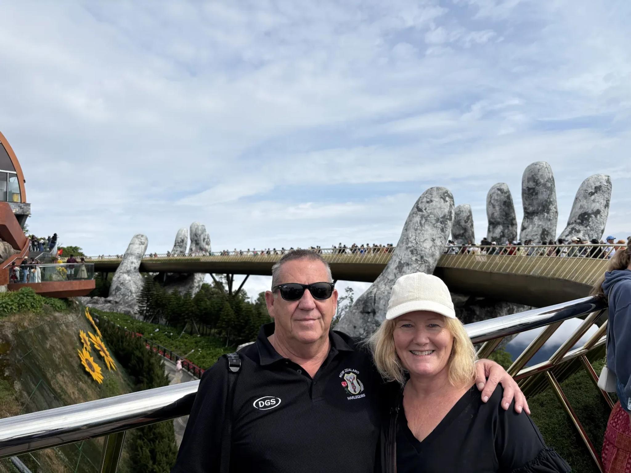 Two Fingo guests in front of the Golden Bridge at Ba Na Hills on a clear morning.