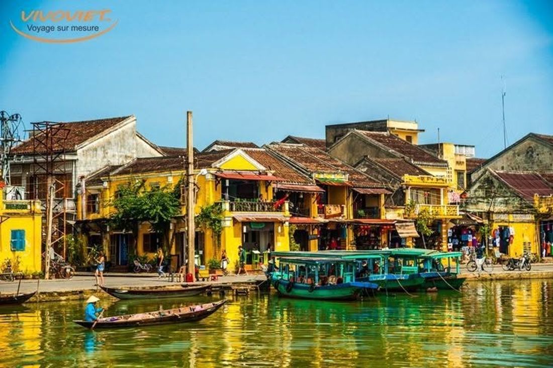 A riverside scene at golden hour in old Hoi An