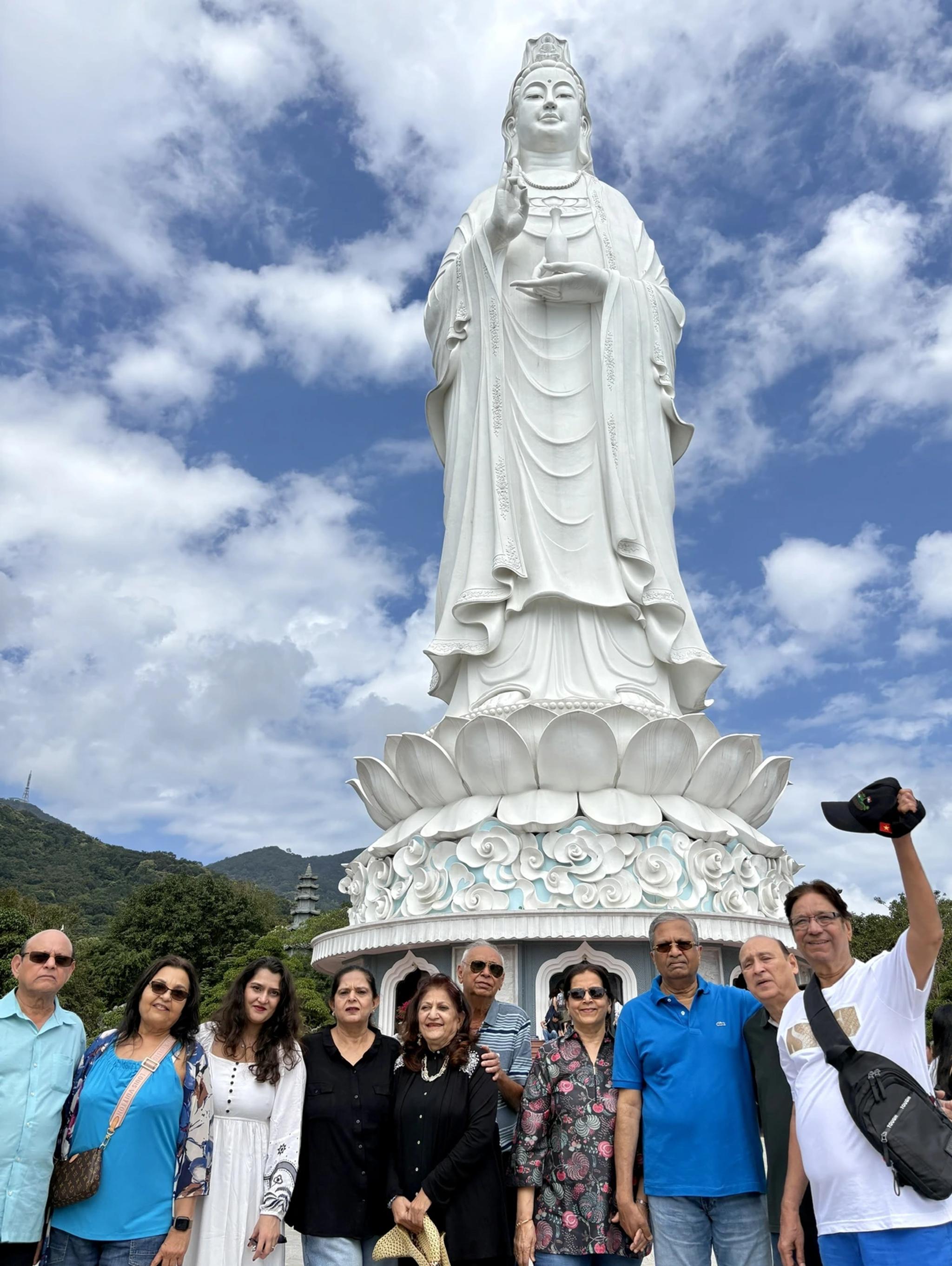 Guests with their guide below the 67-metre Lady Buddha at Linh Ung Pagoda, Son Tra.