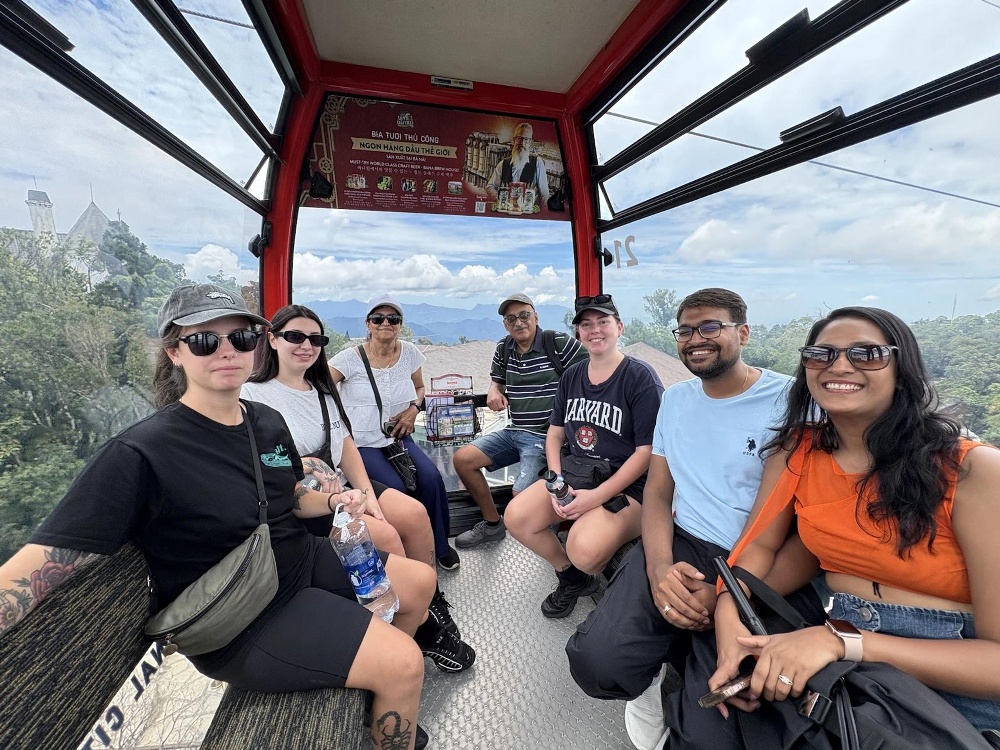 Fingo guests riding the Sun World cable car up to Ba Na Hills, jungle below the cabin.