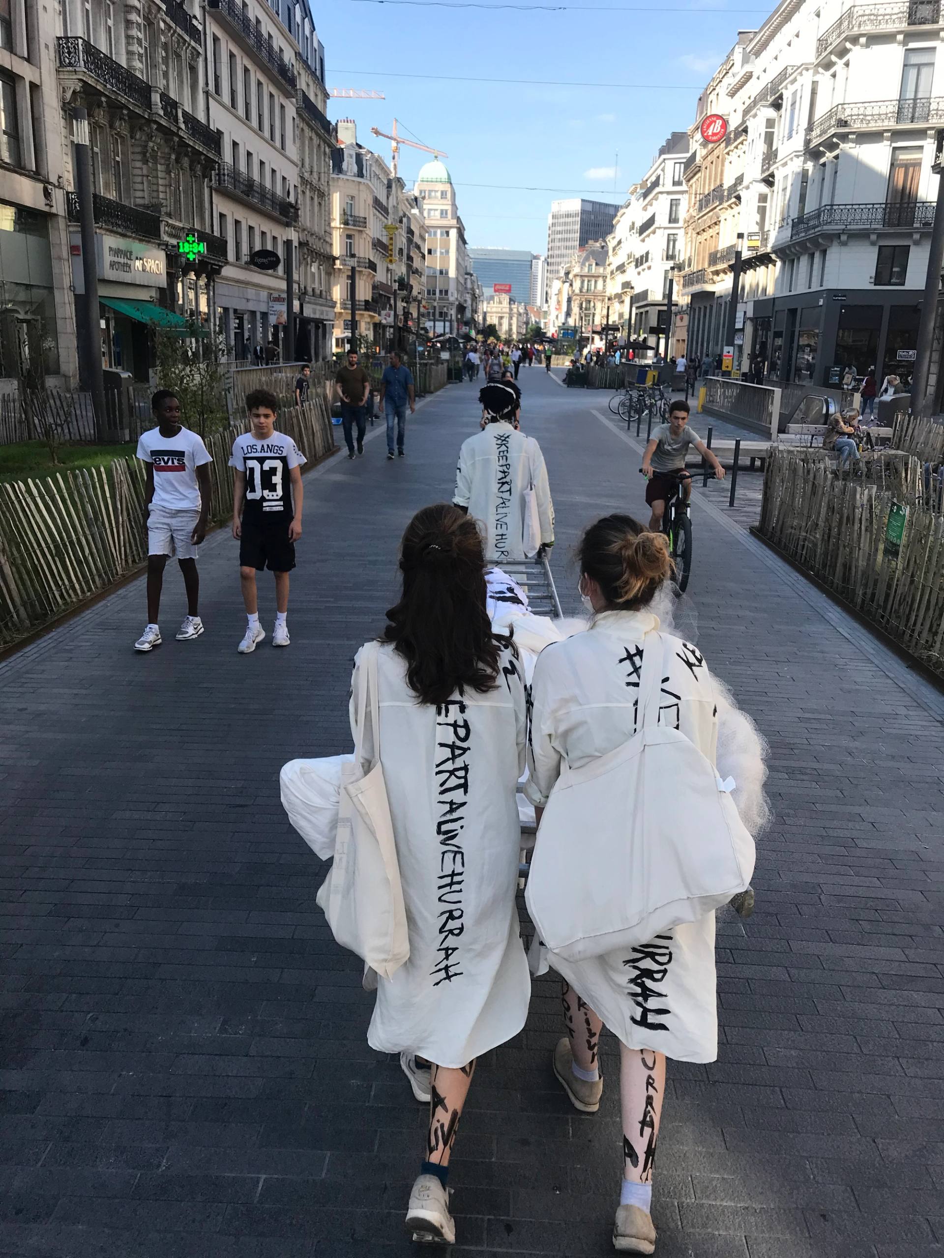 3 performers marching in brussels city center