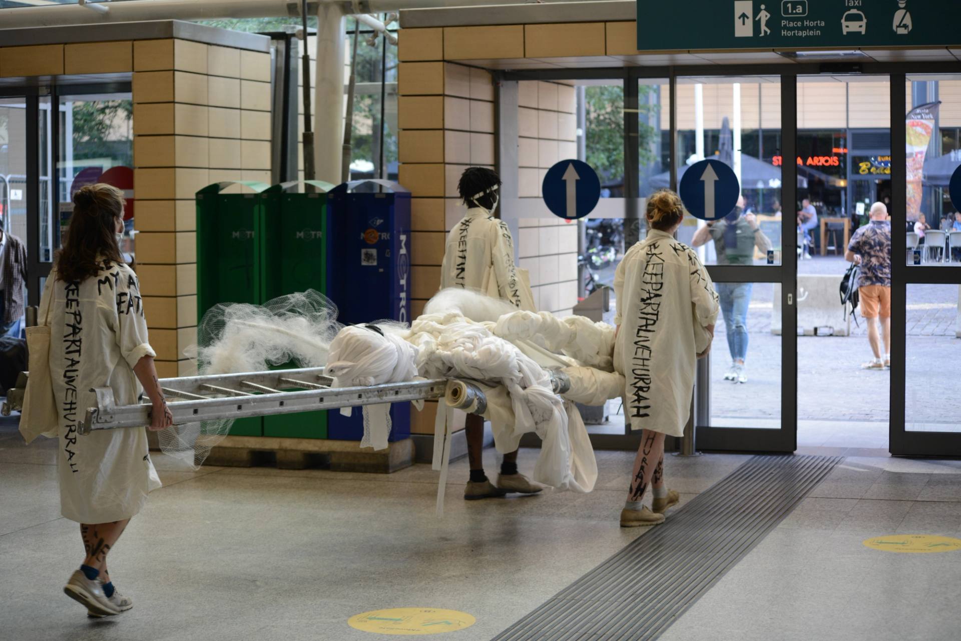 performers crossing the south station in brussels
