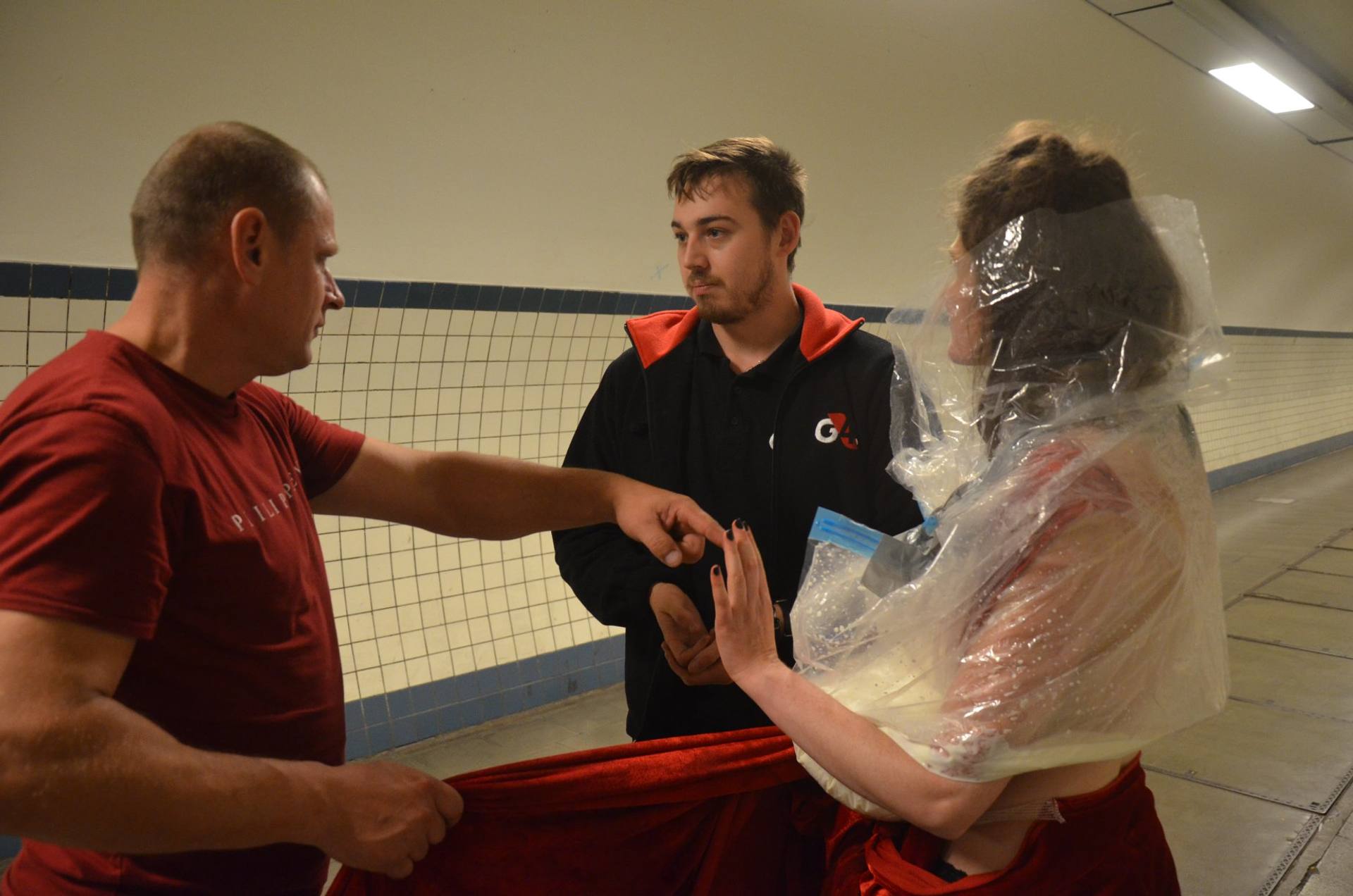 a security person stoipping two people in a tunnel