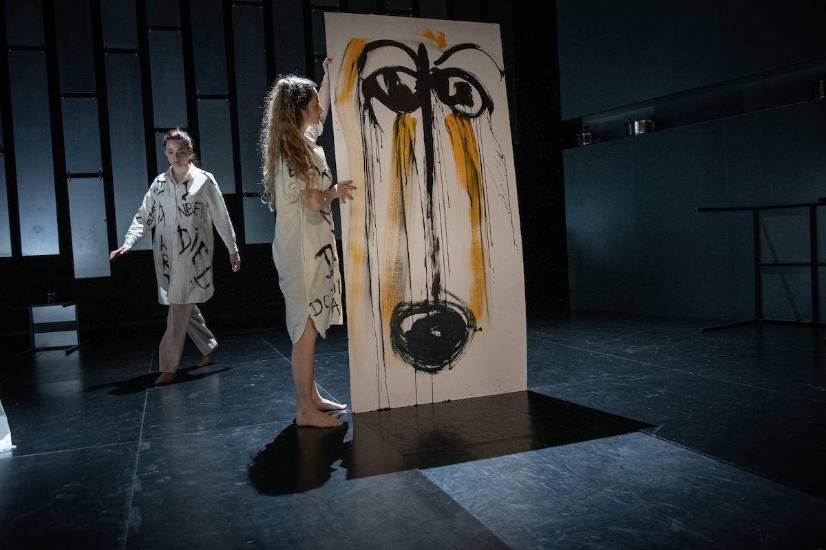 woman lifting up a painting