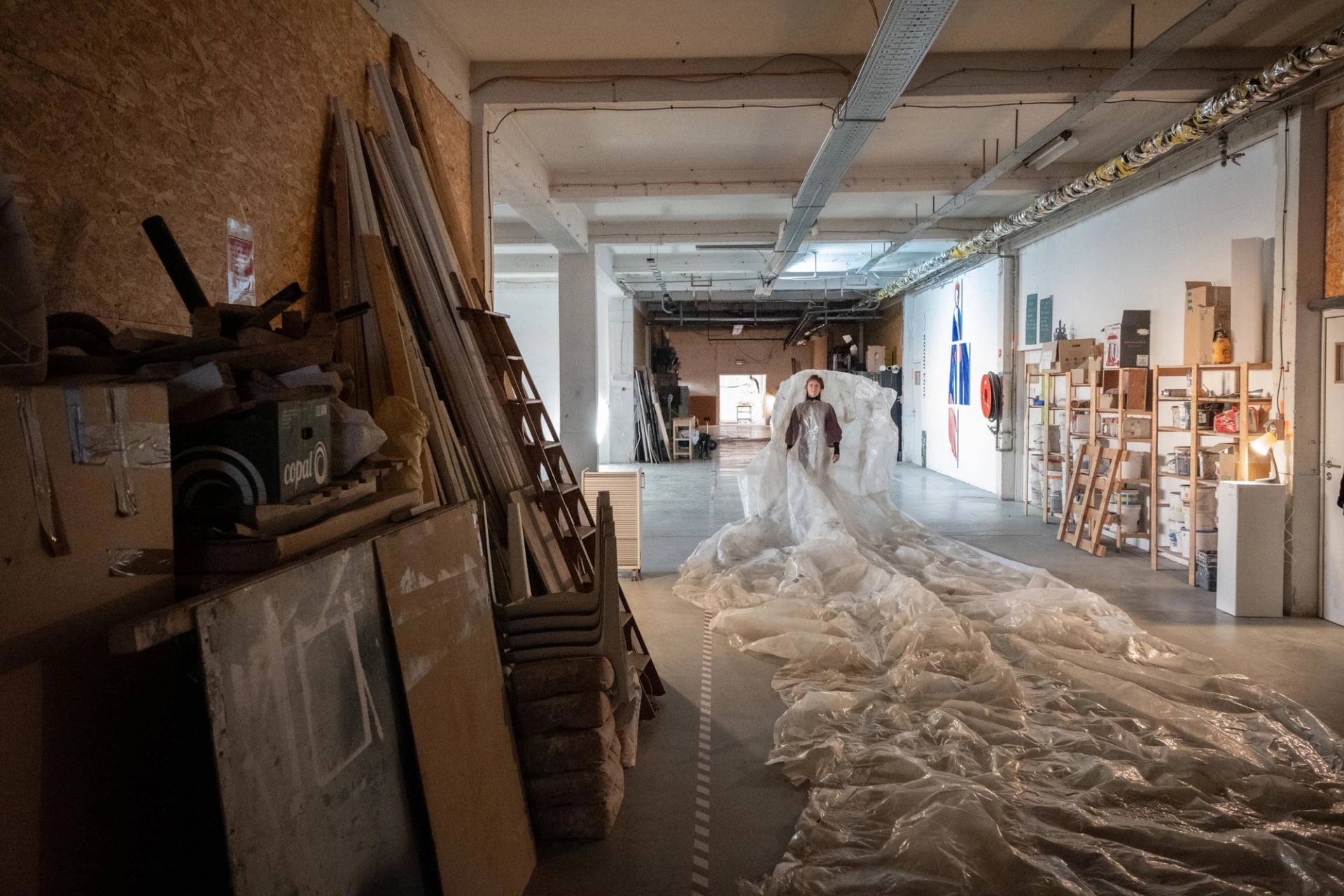 a woman walking backwards in a corridor