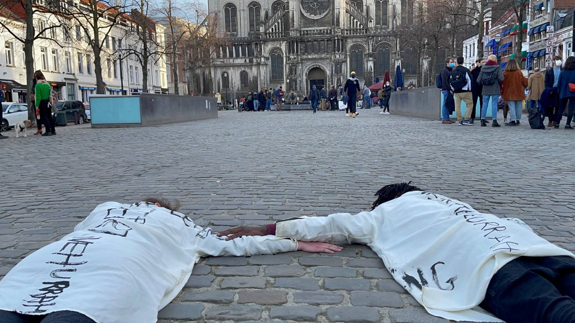 two performers on the floor holding hands