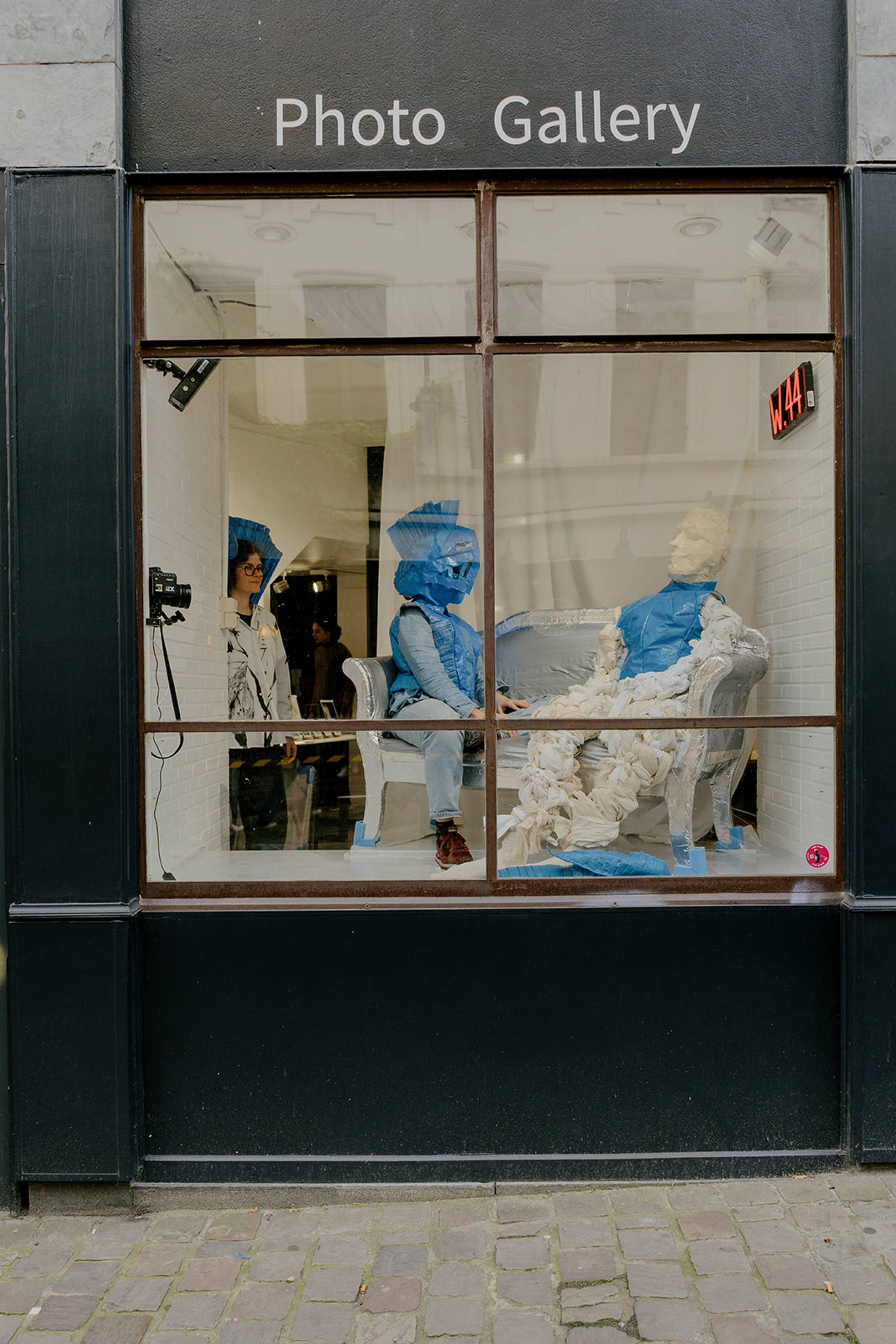 people sitting in a shop window