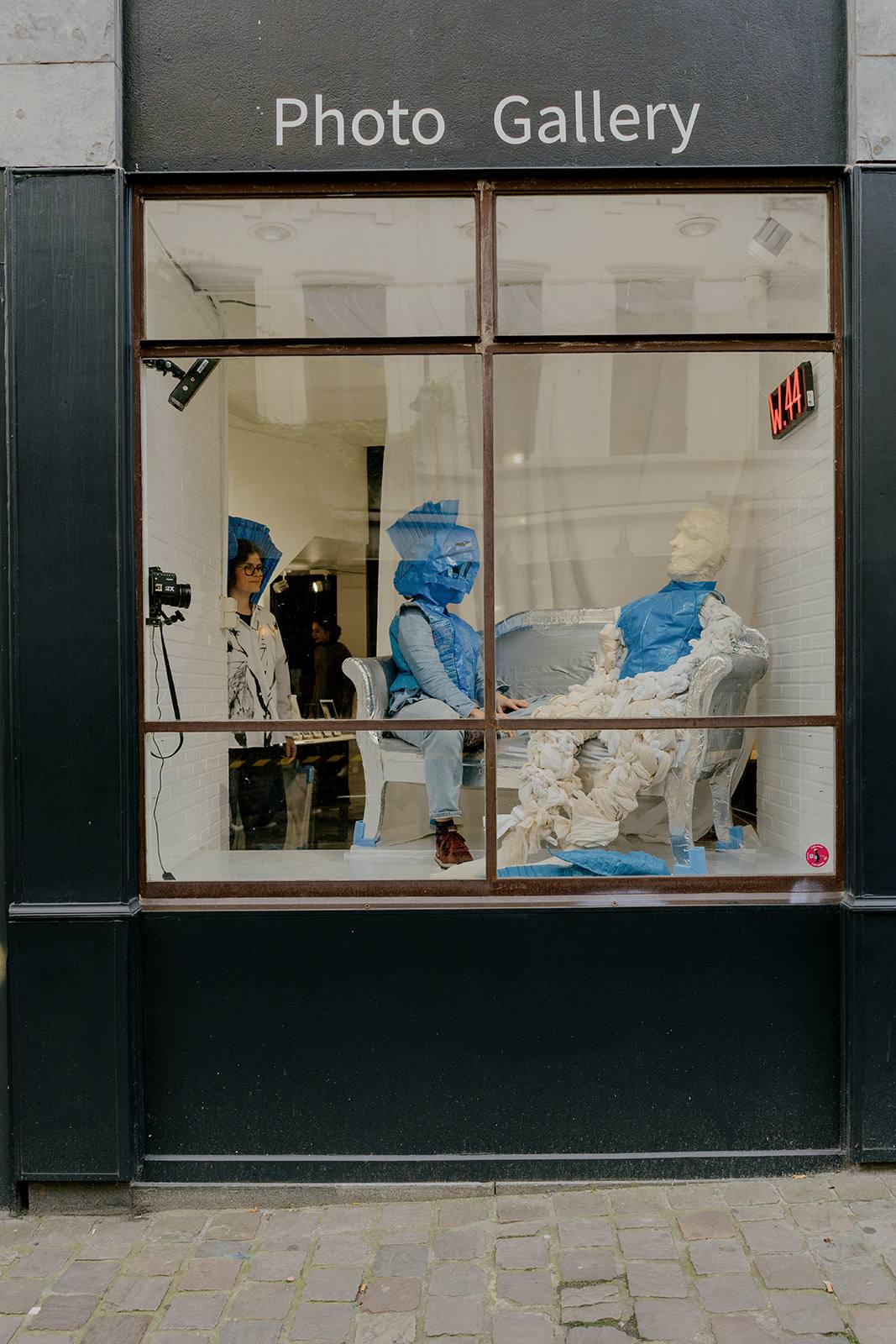 people sitting in a shop window