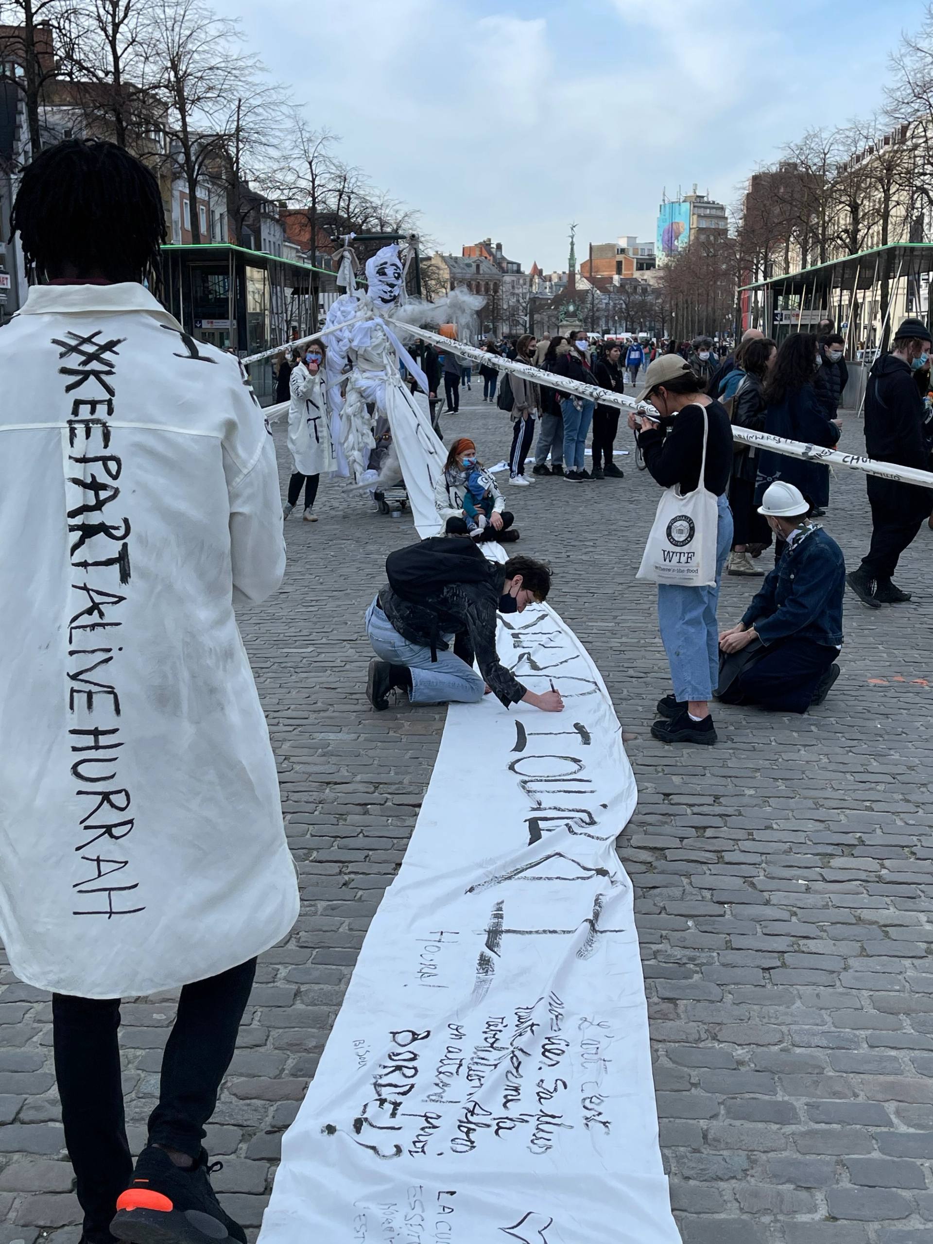 people writing on the hurrah fabric in the public space