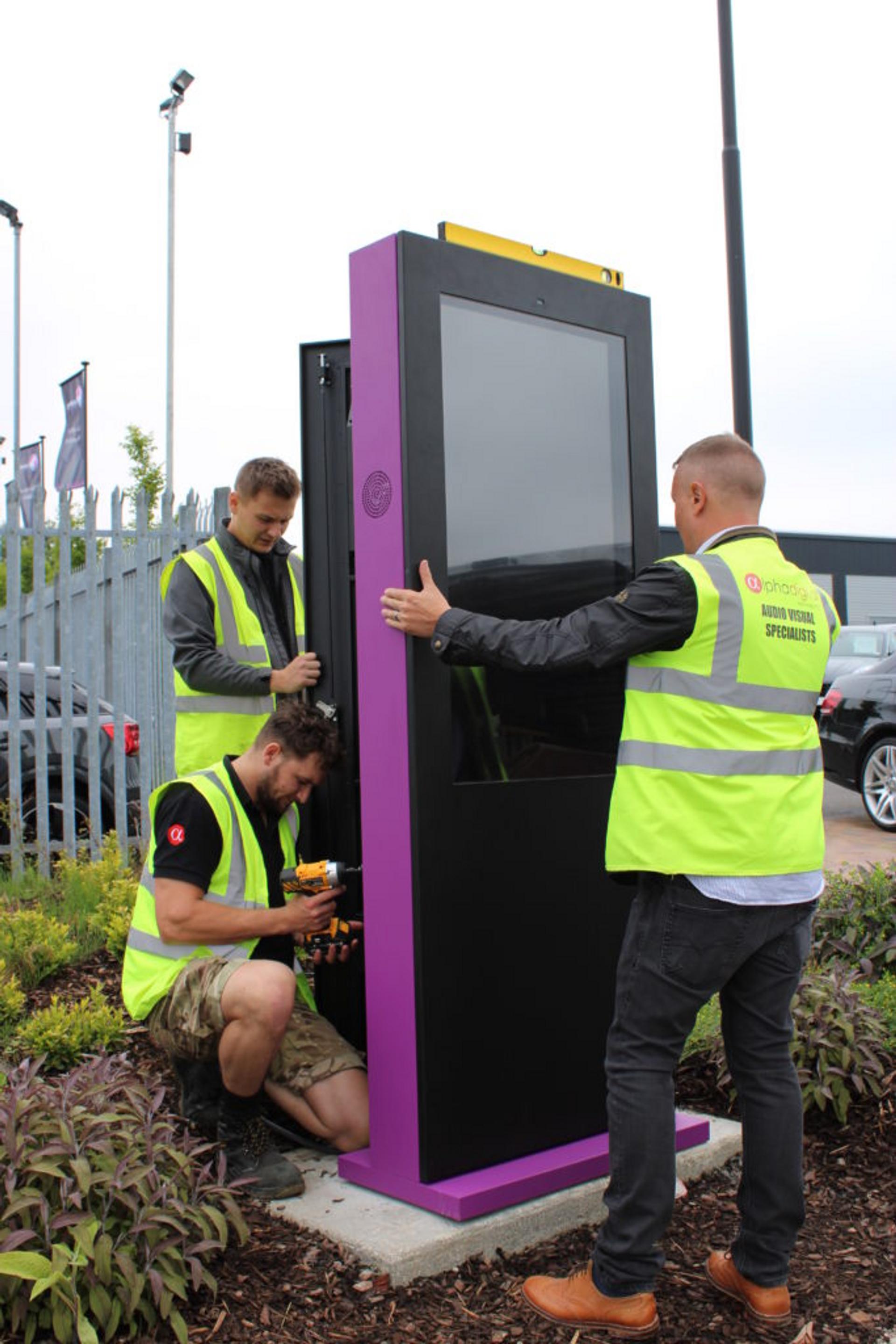 Alpha Digital engineers installing outdoor Totems