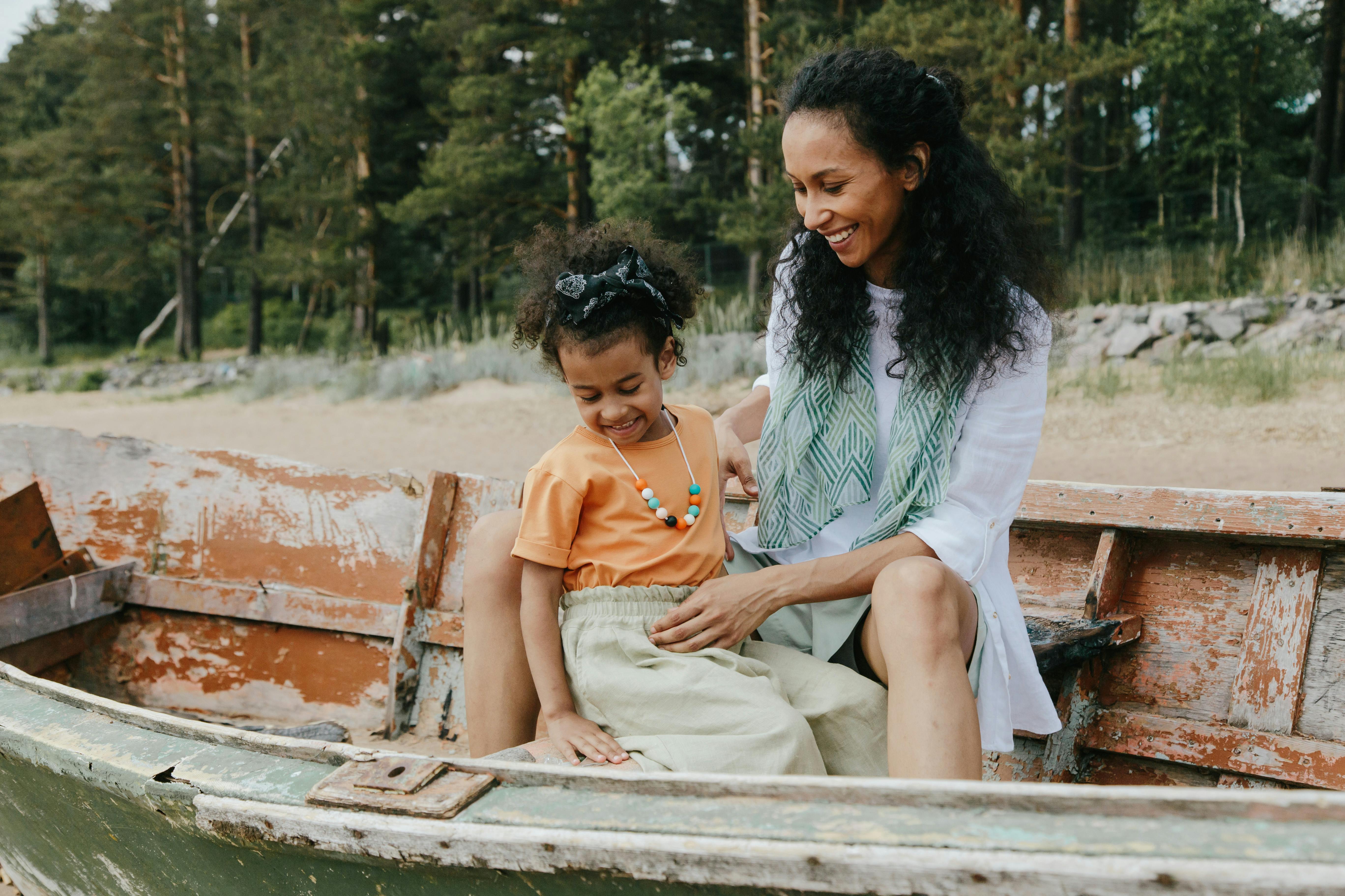 Mother and child sitting together outdoors, reflecting the importance of a clear summer custody schedule for family vacation planning.