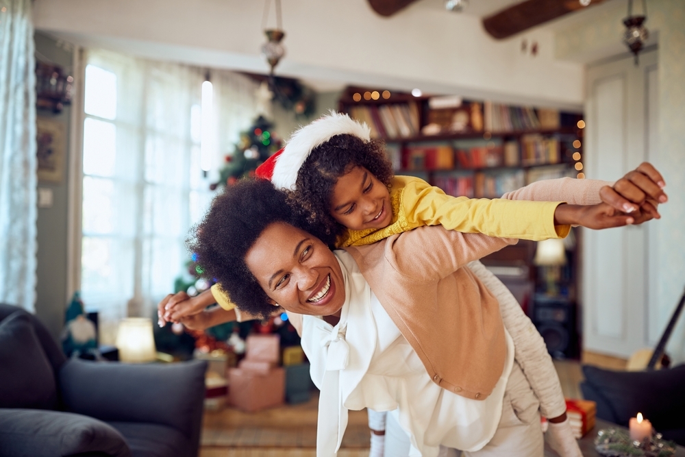 Image Holiday co-parenting tips for first-time co-parents as a parent and child celebrate the holiday season together at home.