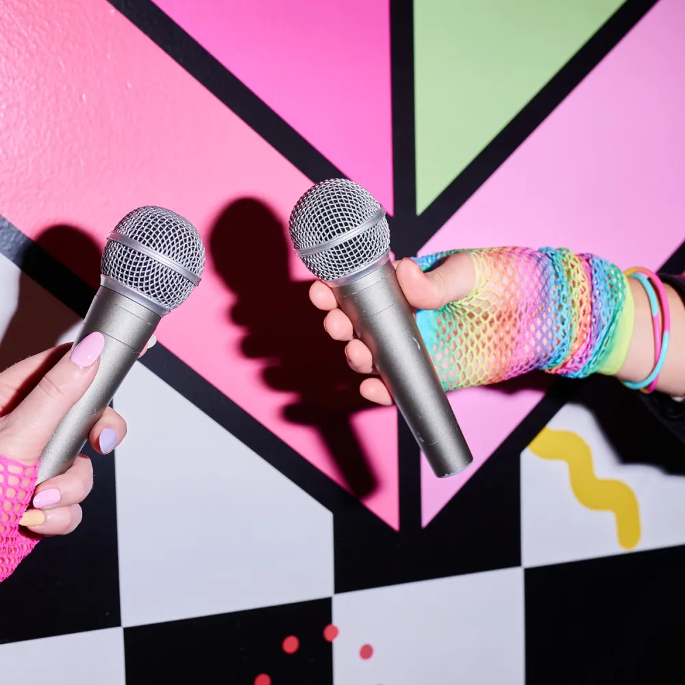 two microphones in front of colourful wall