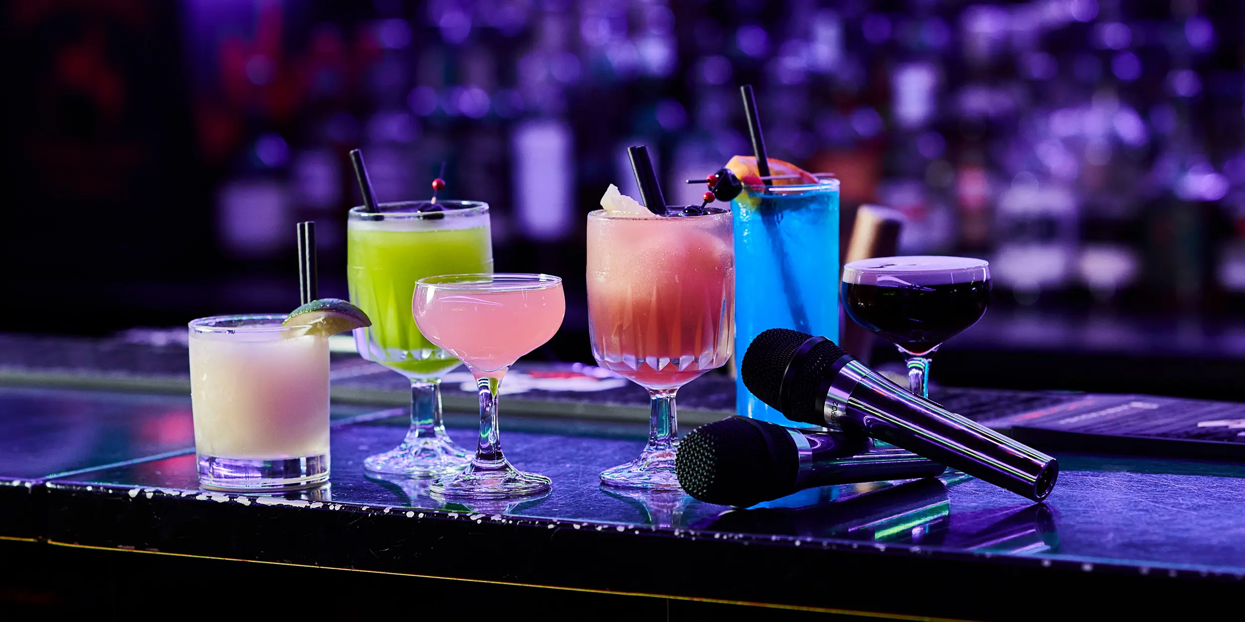 colourful cocktails on bar with microphones