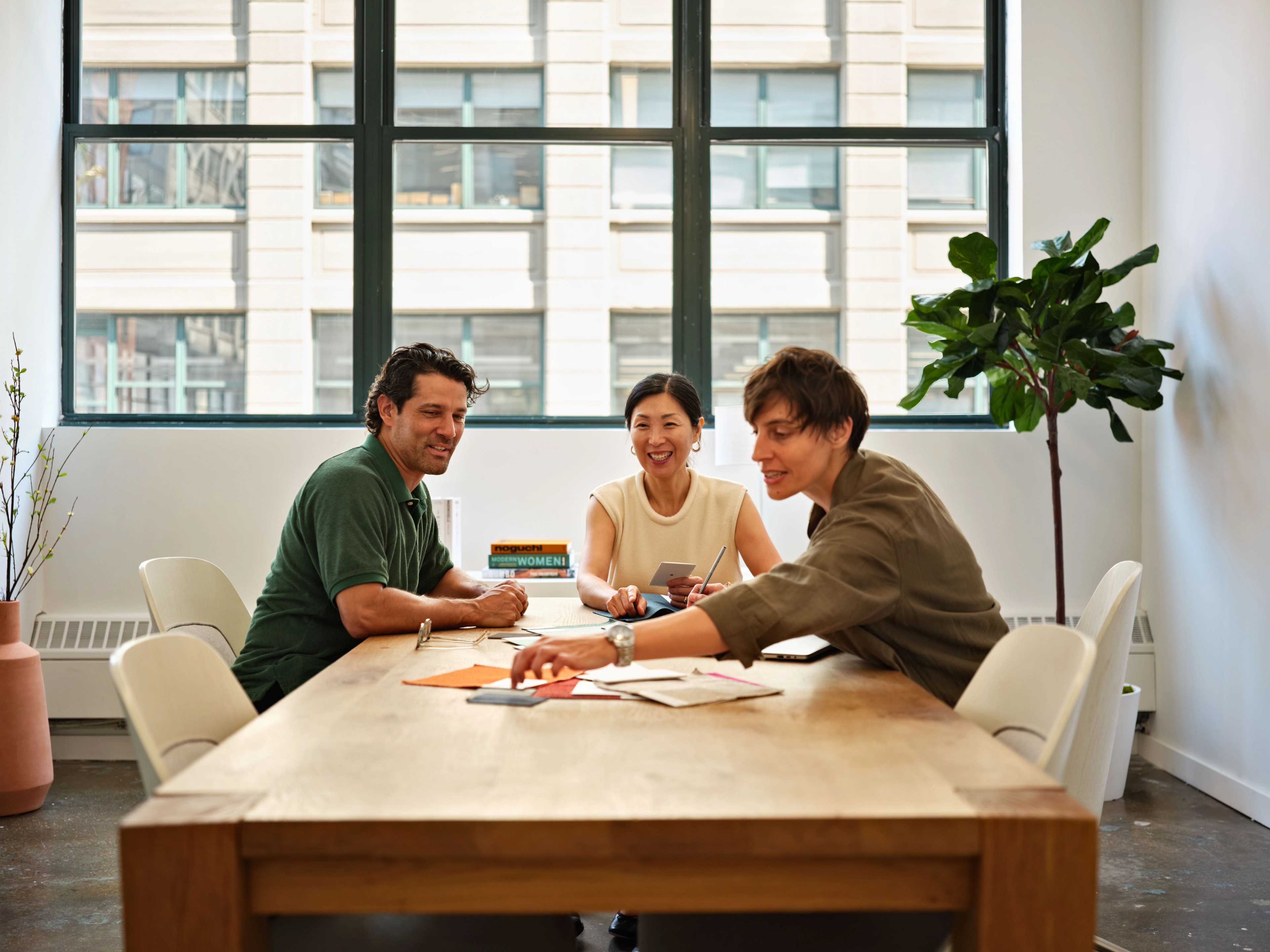 Three people working at conference room
