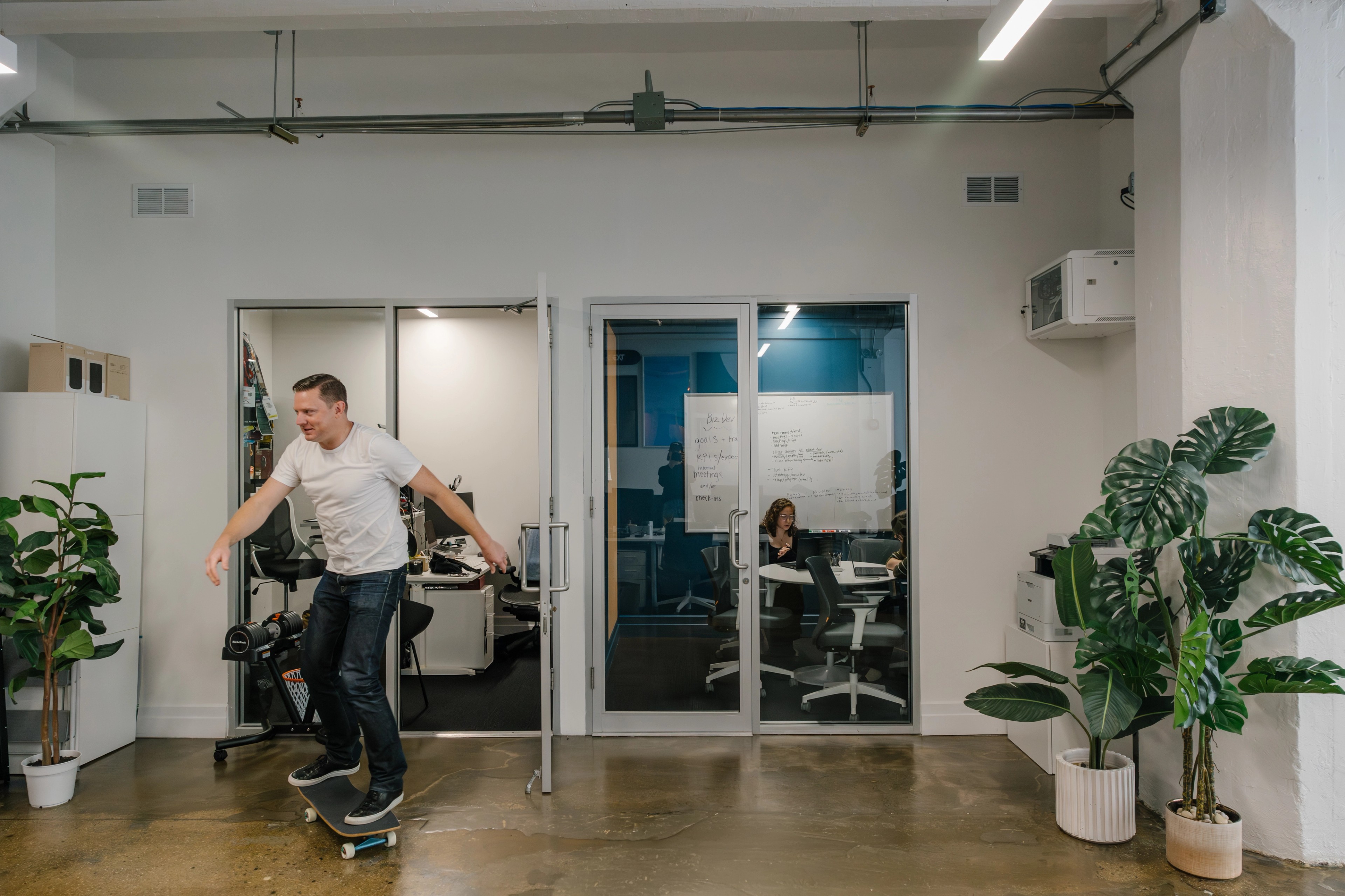 man in an office on a skateboard