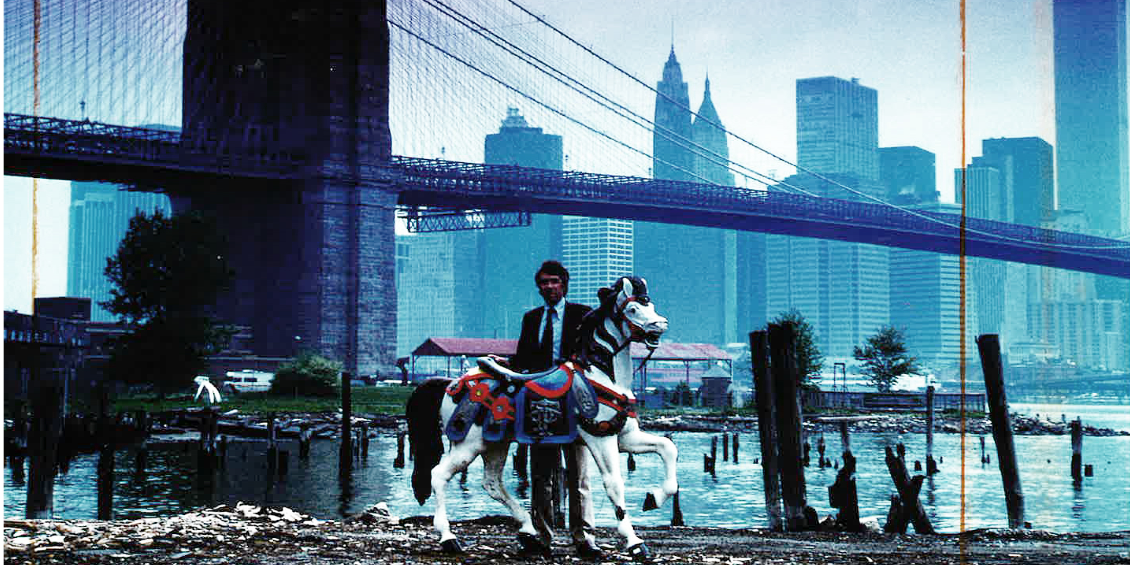 Man holding up carousel house at the future site of Jane's Carousel