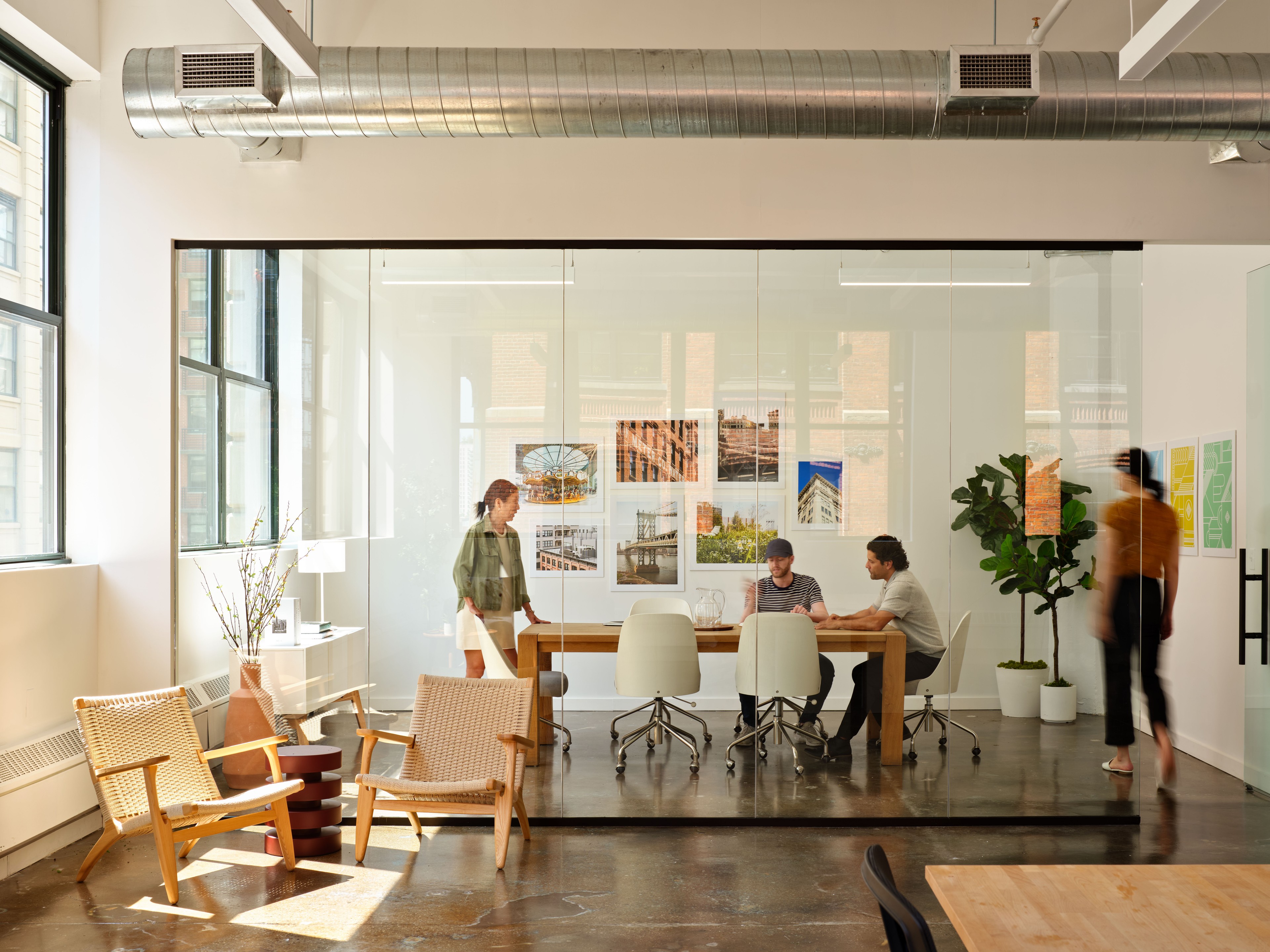 Sunny conference room with four people inside