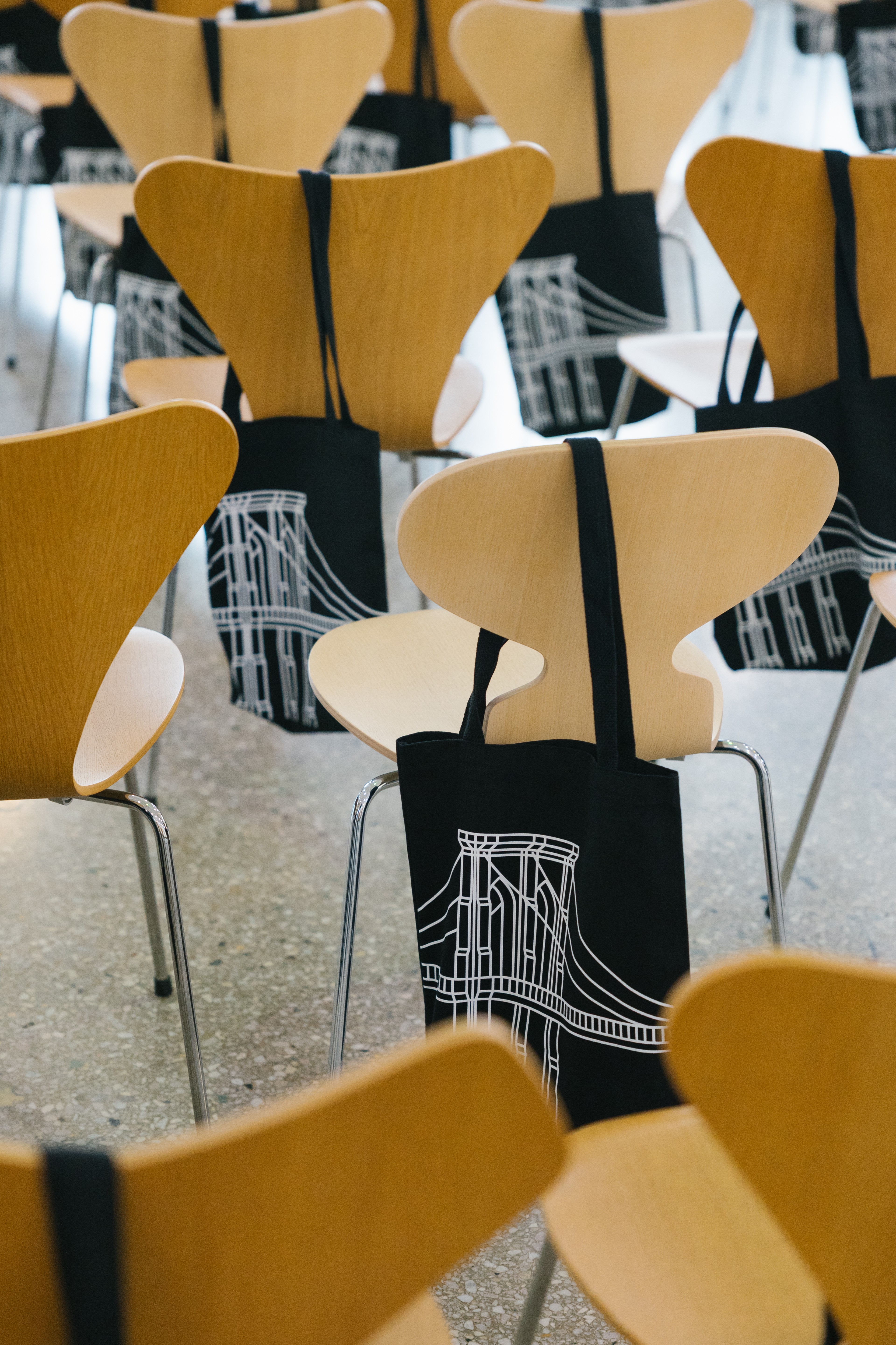 Empty chairs with complimentary DUMBO tote bags