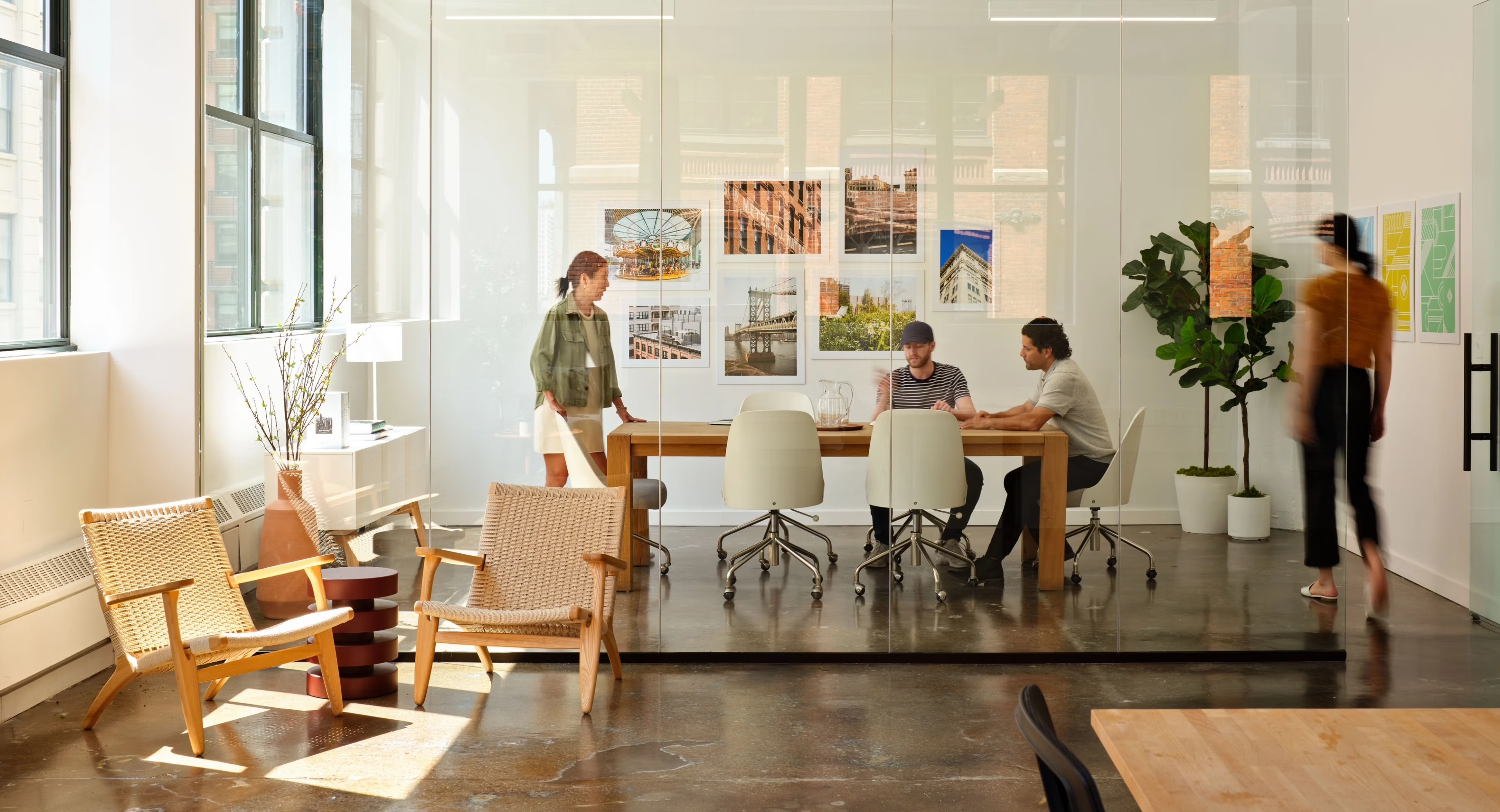 Sunny conference room with four people inside
