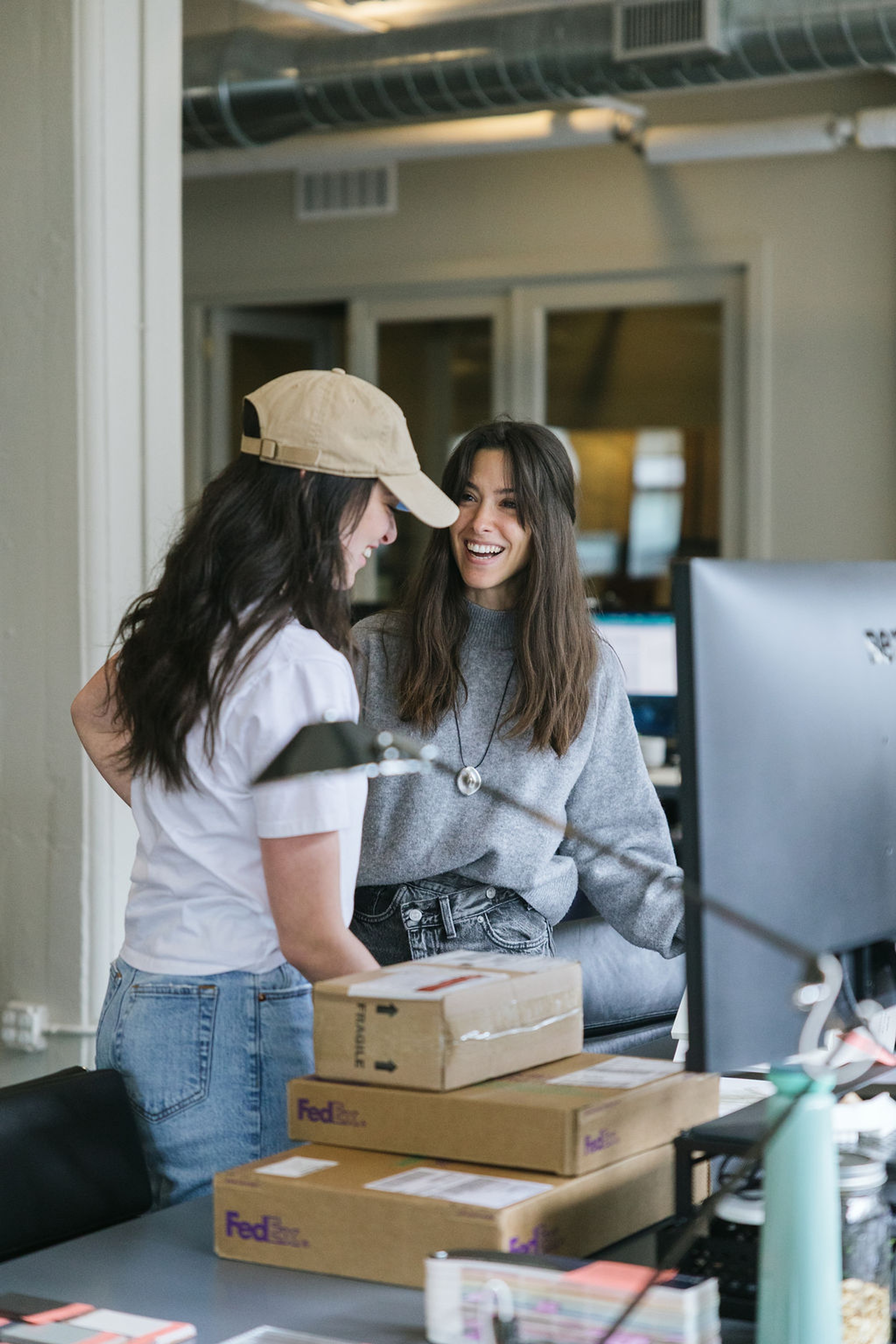 Colleagues smiling over desk