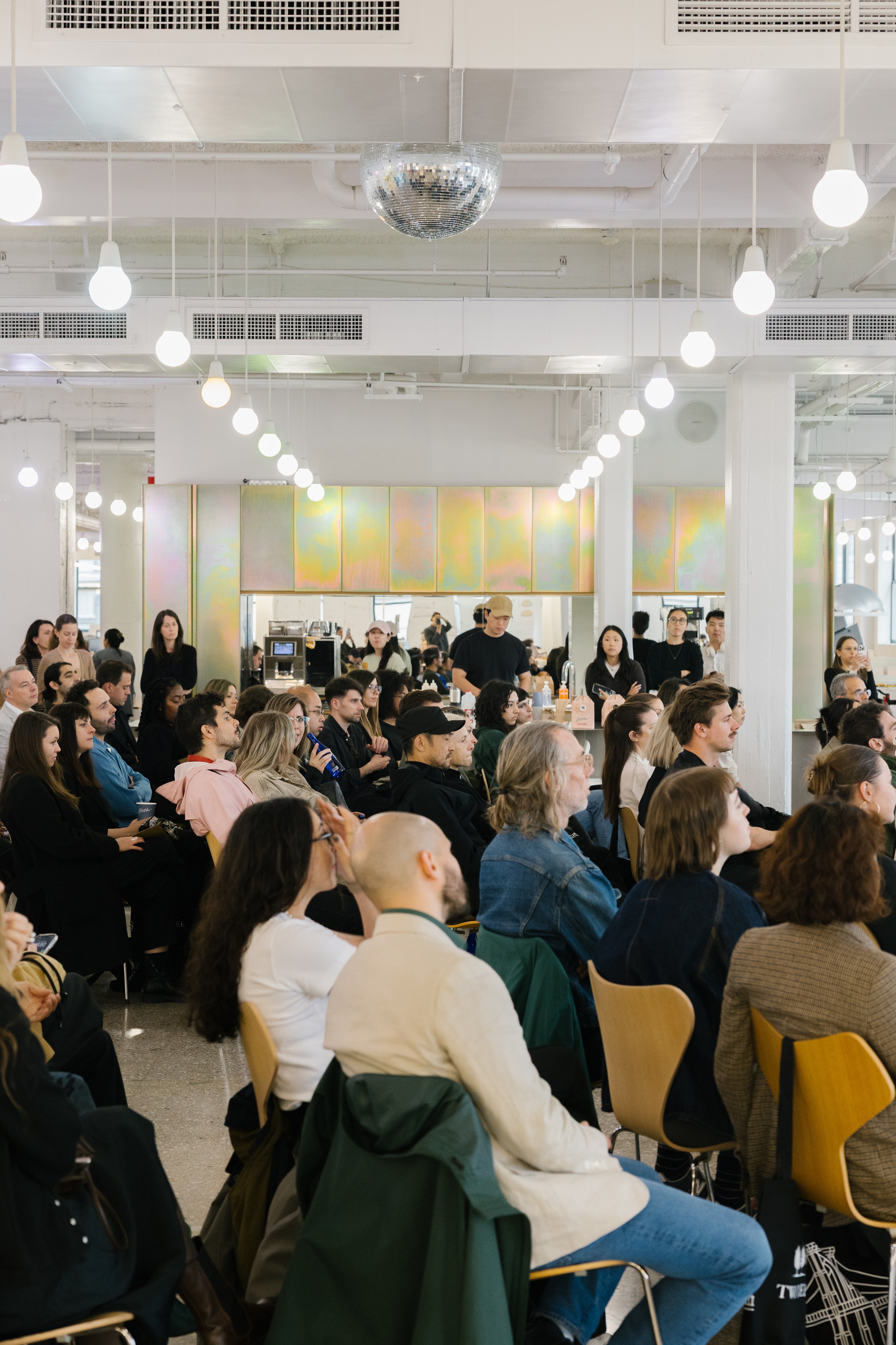 People in a seated audience listening to talk