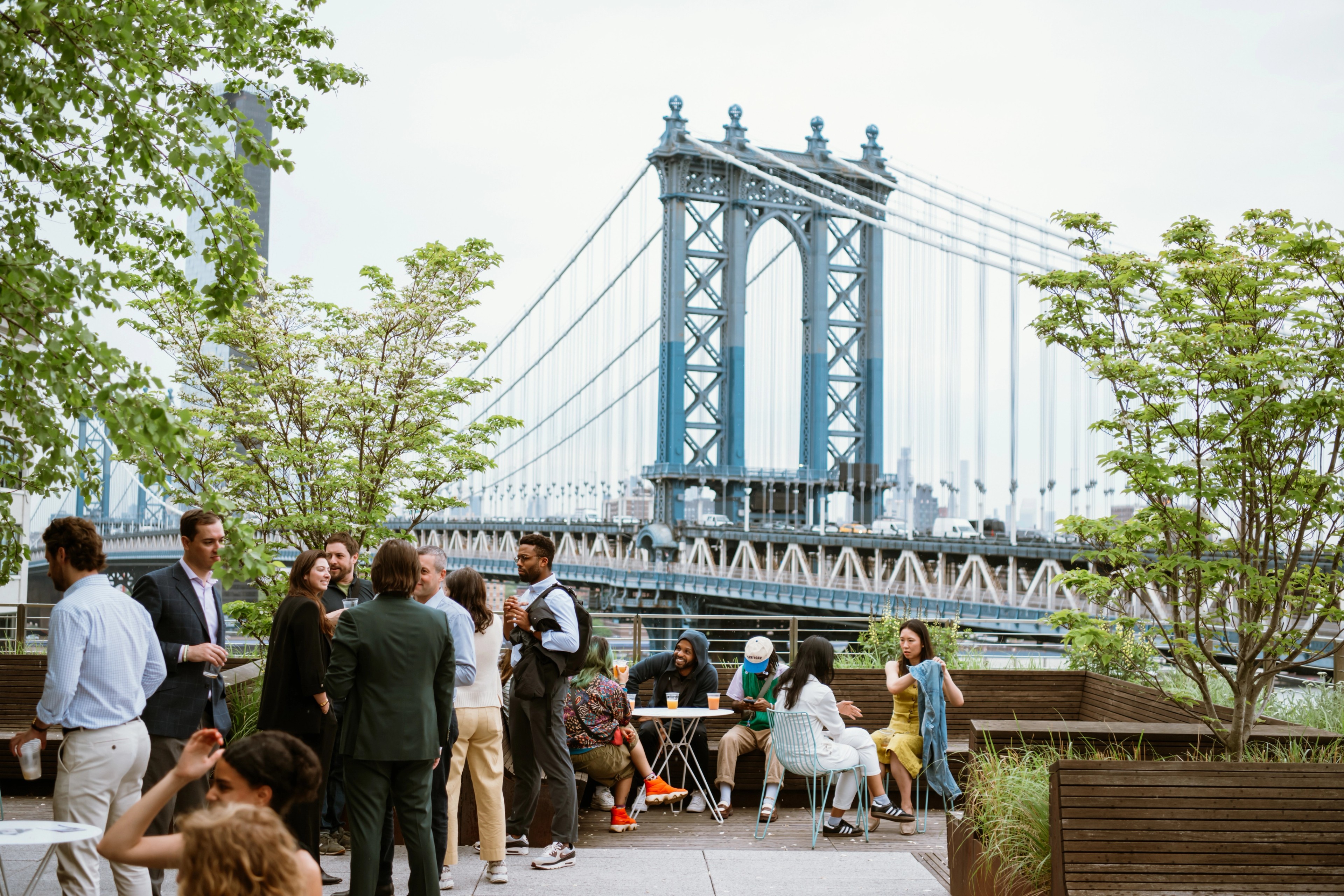 employees socializing on brooklyn rooptop overlooking Manhattan Bridge