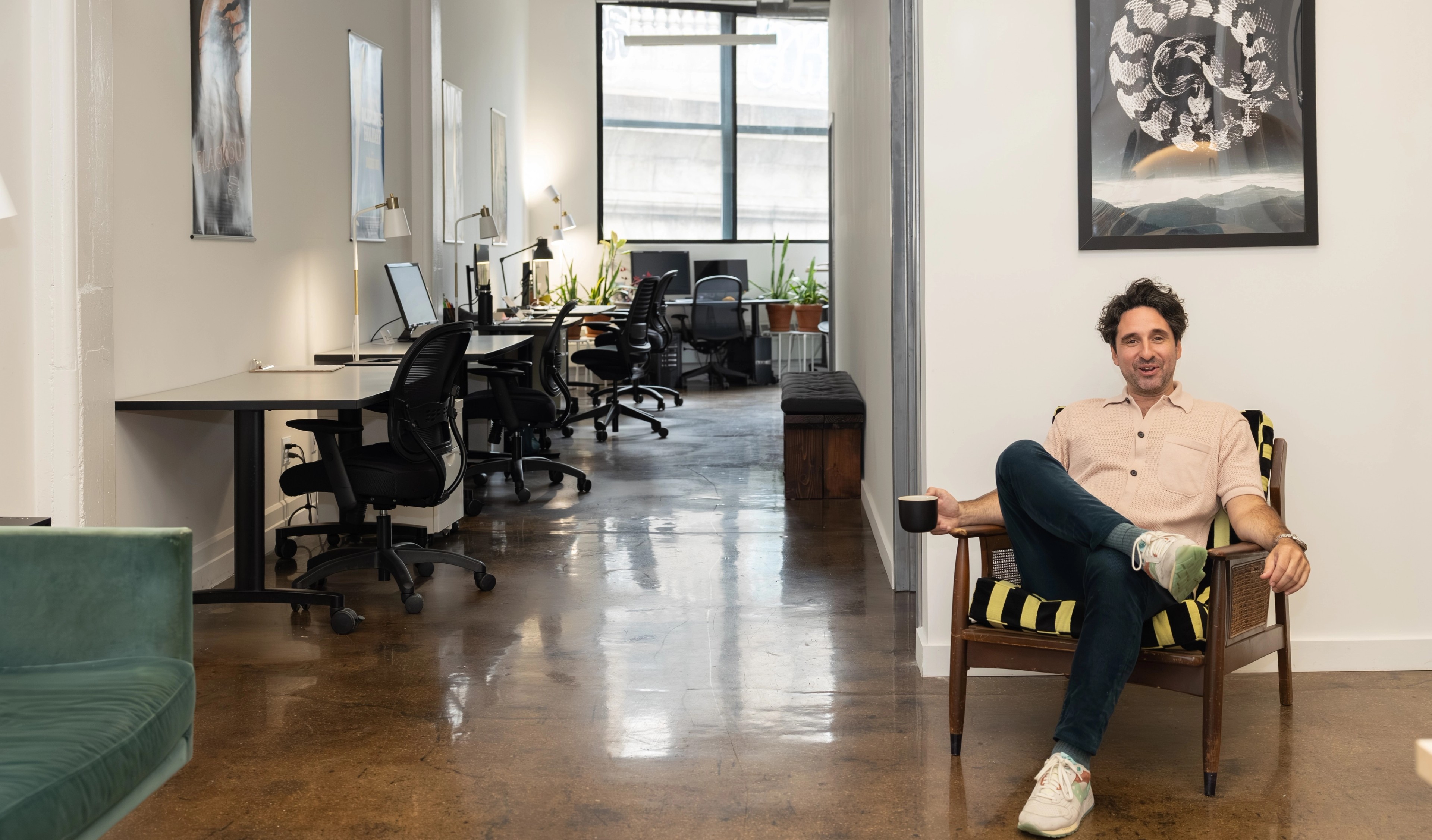 Alex Laviola sitting in the Cut + Measure office