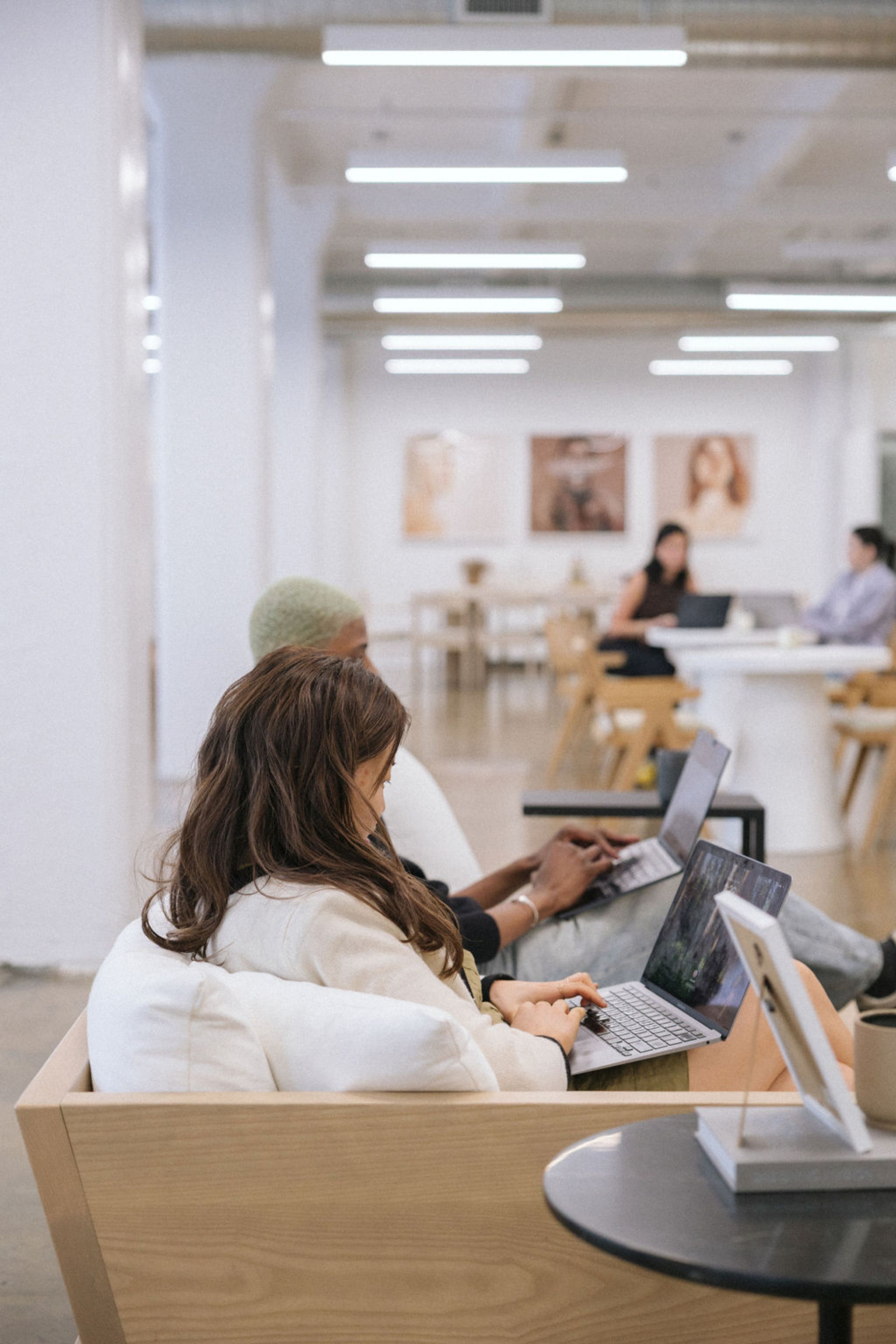 people working in lounge style seating in office