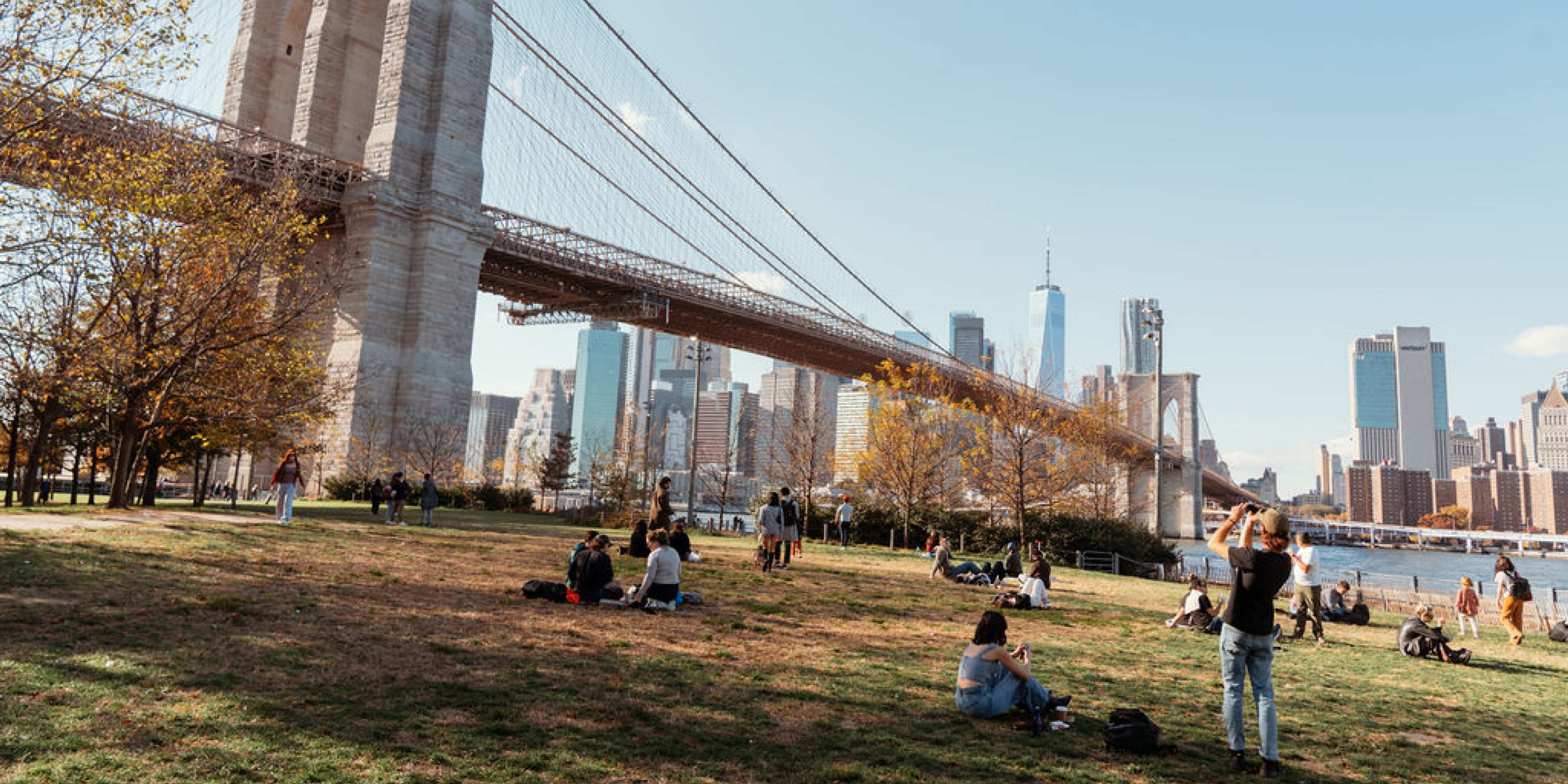 Brooklyn Bridge park in the fall with people having picnics
