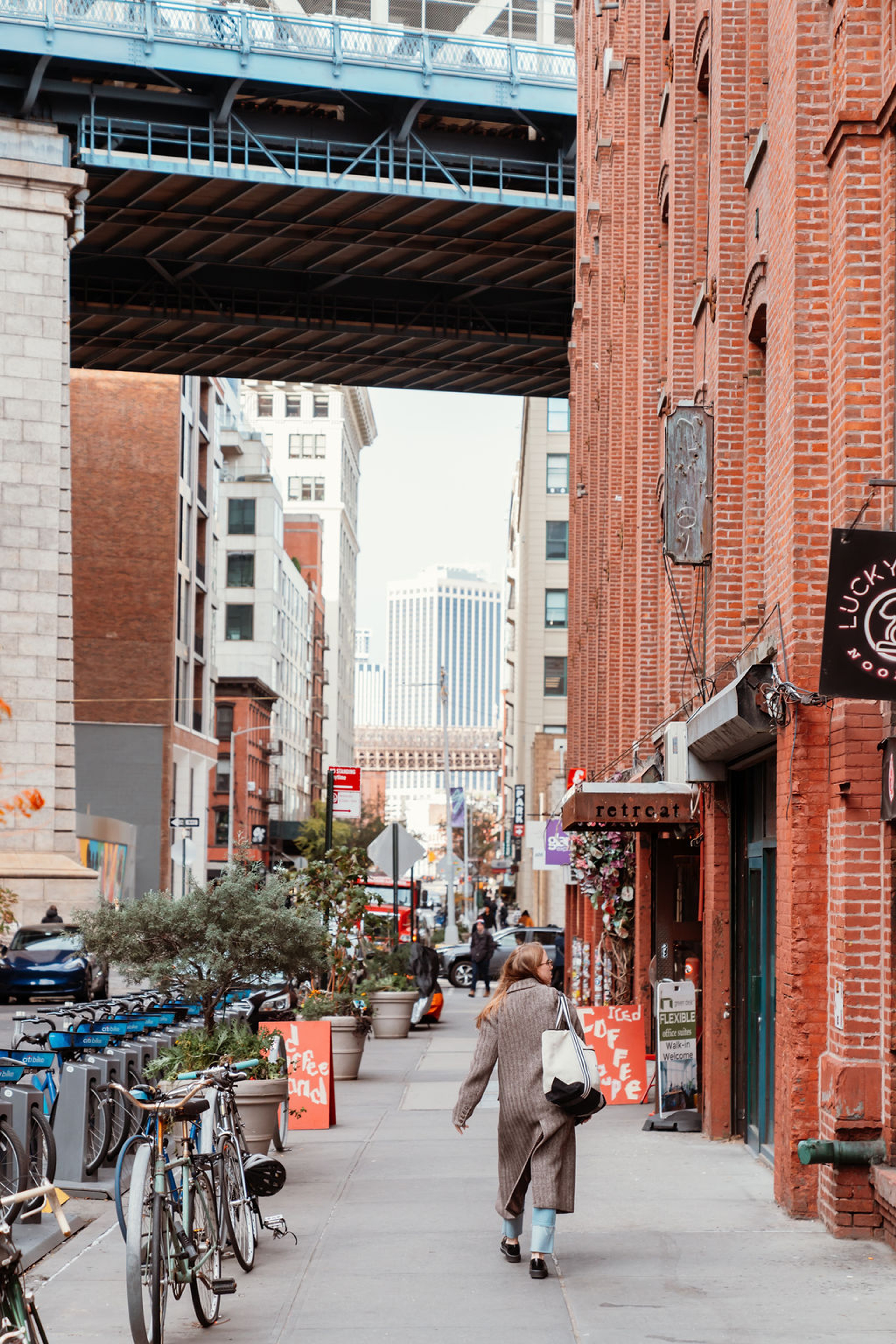 Commuter walking under Manhattan Bridge