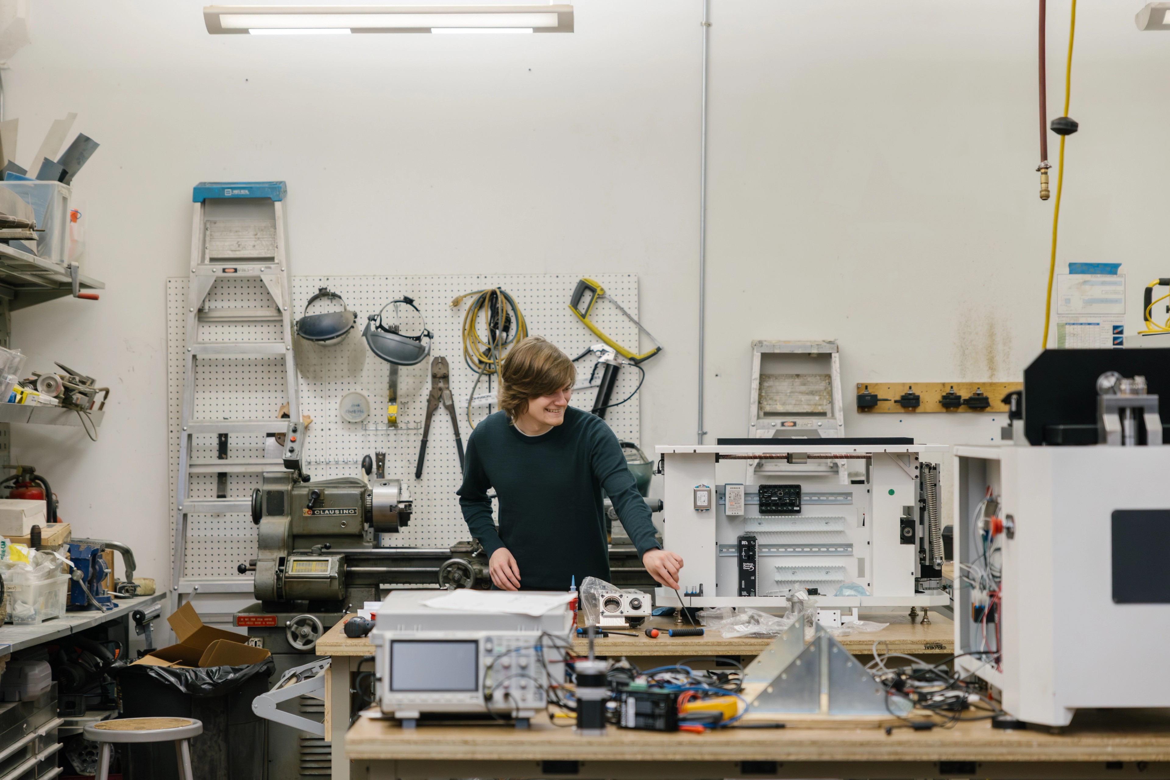 Man at work bench developing a prototype for a client