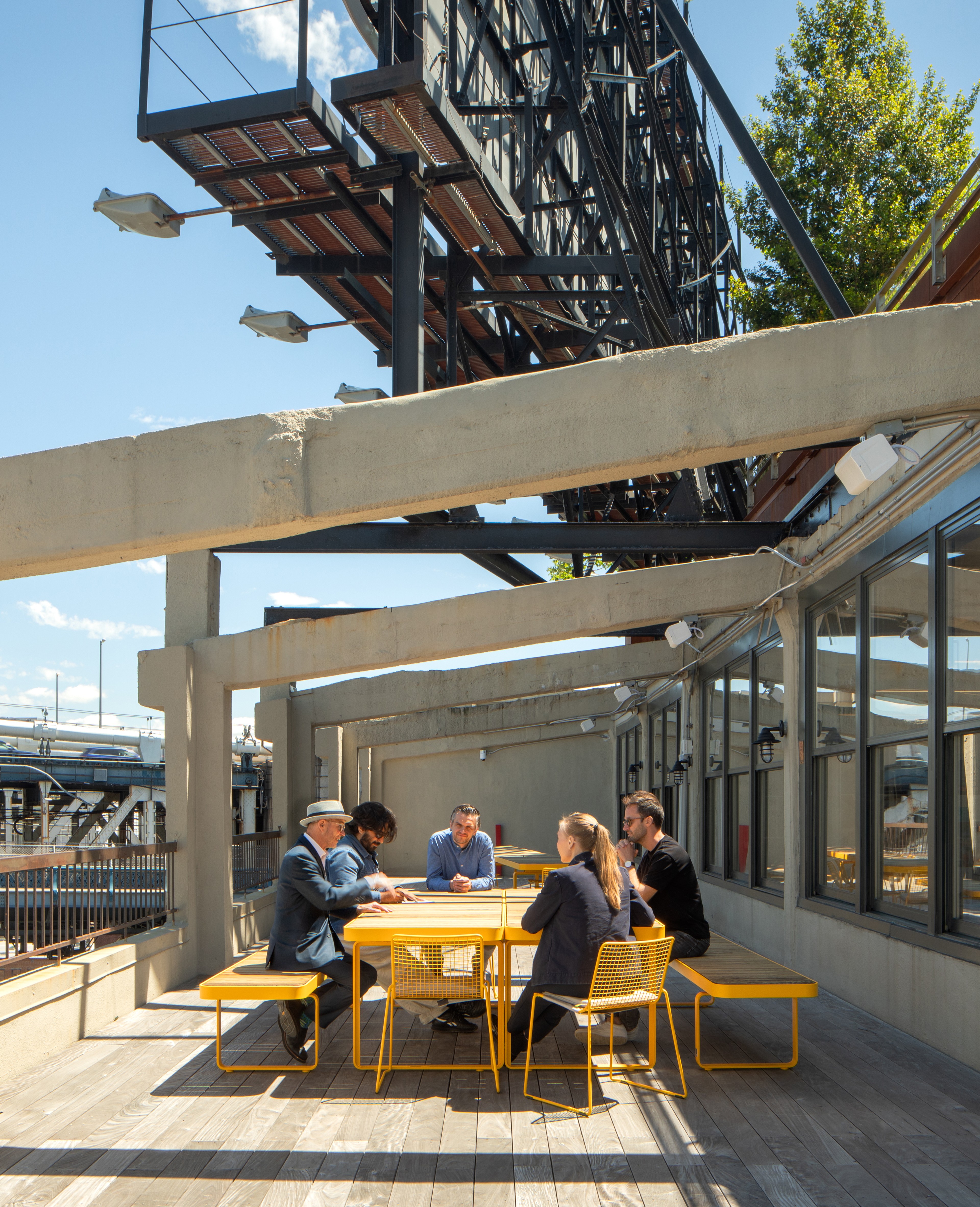 People seated together at a table on roof terrace